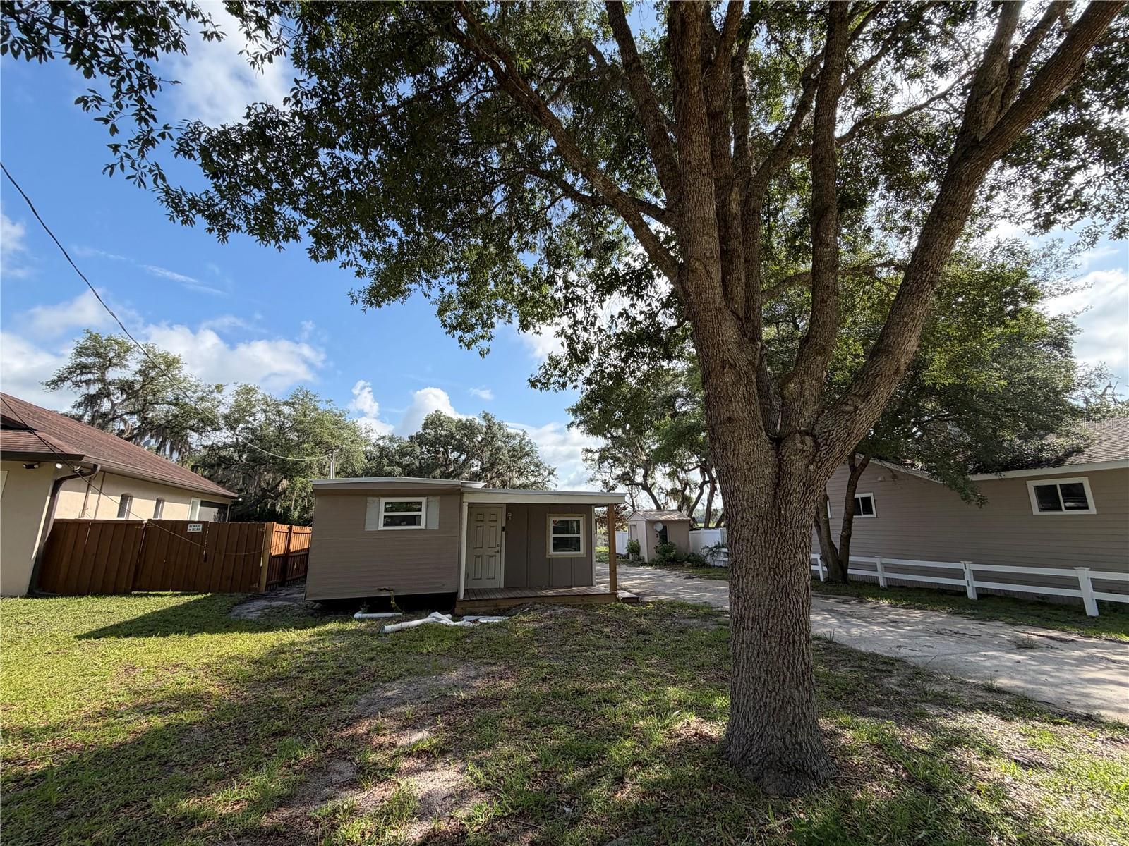 Priced for the buyer who wants to put their own stamp on a waterfront property in the heart of the Ocala National Forest. This canal-front home on Little Lake Kerr is a fixer-upper being sold strictly AS-IS, no repairs will be made. The big-ticket exterior work is already done; the interior is a blank canvas ready for your vision and finishing touches.

The property itself is a standout. A large wood dock with electricity stretches out over the canal, giving you direct water access for fishing, kayaking, or simply soaking in the scenery. The exterior has already seen major investment: a brand-new metal roof, new windows, a new well, a new covered wood back patio, and a freshly finished front porch with new wood. Inside, new flooring has been installed and one bathroom is partially updated with a new vanity and new toilet. The rest of the interior is unfinished and waiting to be completed.

The 0.24-acre partially fenced lot is full of character with mature shade trees, a wood and iron shared fence on one side, a chain-link and vinyl fence on the other, a storage building, and an outdoor firepit for evenings under the stars. Wildlife is part of daily life here. Deer, migratory birds, and freshwater fish are all regular visitors to the canal and surrounding forest.

The location is hard to beat for outdoor lovers. Famous Salt Springs is just minutes away. The surrounding forest offers miles of ATV trails, kayaking routes, freshwater springs, and world-class bass fishing. Ocala and Palatka are a short drive, with Jacksonville, Orlando, and Daytona Beach all within easy reach.

Cash buyers and investors welcome. Vacant and ready to show, bring your contractor and your imagination.