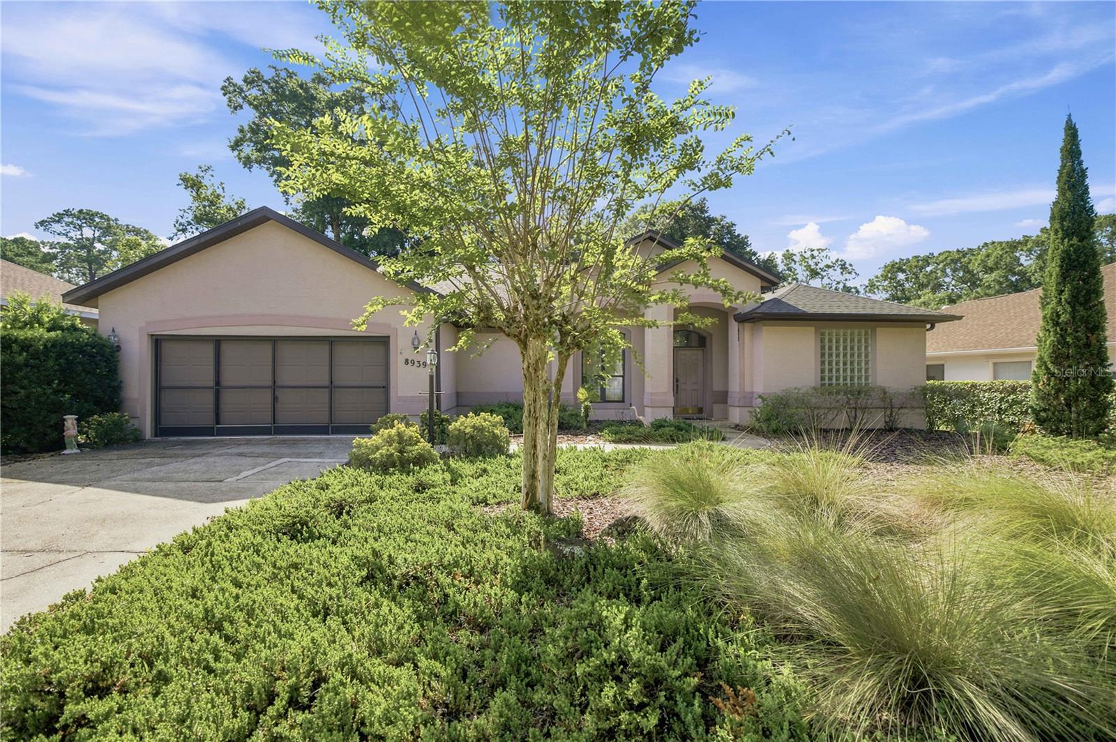 Here is your opportunity to own a piece of paradise in the highly sought after Rainbow Springs Fairway Estates, where residents enjoy exclusive access to the crystal clear Rainbow River. This exceptional community features a private river park located just south of the head spring at Rainbow Springs State Park, one of the area's most coveted amenities. Residents also enjoy a private beach, pavilions for gatherings, a community pool, fitness center, tennis and pickleball courts, and a vibrant community center.  Designed with entertaining in mind, this spacious home offers an open-concept floor plan that seamlessly connects the living room, dining area, and kitchen. Two oversized three-panel sliding glass doors open to an expansive 624 square-foot screened lanai complete with an outdoor kitchen. One slider fully pockets, creating a true indoor/outdoor living experience that's perfect for hosting family and friends. The thoughtfully designed split bedroom floor plan provides privacy for the spacious primary suite, which features direct lanai access, dual walk-in closets, separate vanities, a relaxing soaking tub, walk-in shower, and private water closet. The guest bedrooms are situated on the opposite side of the home, offering comfort and privacy for family or visitors.  Adding to its appeal, the home overlooks the former golf course, providing peaceful views and plenty of open green space for walking, exercising, or enjoying time with your four-legged family members. With some updates and personal touches, this property has the potential to become a truly stunning primary residence, seasonal retreat, or investment opportunity.  Located just minutes from historic downtown Dunnellon, you'll enjoy charming local shops, restaurants, and endless outdoor recreation. Spend your days kayaking, paddleboarding, tubing, or swimming in the world-famous Rainbow River, or take a short drive to Ocala and the renowned World Equestrian Center, approximately 15 miles away.  Whether you're searching for a full-time residence, vacation getaway, or investment property, this home offers an unbeatable combination of space, location, and an incredible Florida lifestyle. Schedule your private showing today and experience the Rainbow Springs community.