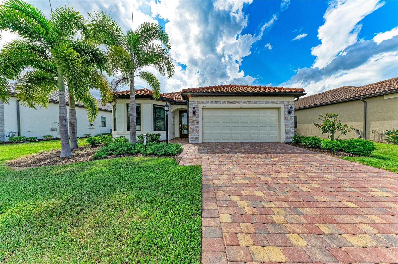 Owner's loss, YOUR GAIN! Why live in a construction zone when you can live in this fabulous one story single family with over $125,000 in upgrades since 2024?! Welcome to this beautifully upgraded Mystique model with extended lanai in the highly desirable 55 Plus community of Del Webb Lakewood Ranch. Perfectly positioned with a peaceful water view and tucked away from the busier roads, this home also enjoys close proximity to the secondary community pool and amenities for added convenience. The extended covered lanai is one of the standout features of the home, offering tranquil water views, remote-controlled hurricane-rated storm screens, and a solid privacy wall that creates the potential for future enclosure if desired. There is also room for a future pool. 

This thoughtfully designed 3-bedroom plus study home offers 2,084 sq ft of open living space with porcelain tile throughout, quartz counters throughout, custom trim work, custom lighting, dimmer switches, ample ceiling fans throughout, 8 ft doors, and elegant custom paint finishes. The spacious study with solid double doors provides flexibility for a home office, den, or guest overflow space. 

The kitchen features an oversized quartz island, abundant cabinetry, induction cooktop with custom overhead venting system, wall oven, separate microwave, walk-in pantry, and an open flow into the dining and living areas-ideal for entertaining. The natural gas line is currently capped as a future alternative if preferred. All major appliances are included with the home.


The primary suite offers a spacious and thoughtfully designed retreat with a large walk-in shower, dual vanities, quartz counters, tile extended to the ceiling for an elegant finish, grab rails for added convenience, a linen closet, and a large customized walk-in closet. Pocket doors in two locations enhance the overall flow and functionality of the suite, including the private water closet area.

The secondary bedroom features upgraded impact-rated bay windows that enhance both natural light and storm protection. The remaining windows include professionally installed 3M protective film for additional comfort and peace of mind. The guest bath also includes grab rails and tile extended to the ceiling, creating a refined and cohesive design throughout the home.
Additional upgrades include a whole-house generator, hurricane shutters, epoxy garage floor, high-end electric washer and dryer with pedestals, and an exceptionally functional laundry room complete with a sink with cabinet, second refrigerator, custom wall closet system, upper storage, clothes drying rods, and a large storage area. The relocation of the air handler to the garage ceiling creates additional usable laundry and storage space while contributing to quieter interior living areas. 
Del Webb Lakewood Ranch offers resort-style amenities including pools, fitness center, clubhouse, "Cheers" restaurant, pickleball, tennis, social activities galore, and gated entry-all within one of the nation's premier master-planned communities in the country, Lakewood Ranch.
