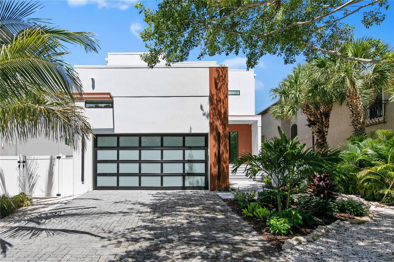 Sophisticated and sleek, this dazzling masterpiece is located along the grand canal in the heart of Siesta Key. A modern exterior will impress neighbors and onlookers with sharp lines and a refined combination of materials that blend style and durability for island living. A courtyard provides a private entrance for you to welcome guests into the two-story foyer illuminated by an intriguing chandelier. An adjacent study featuring custom metal French doors is the perfect spot to accomplish business endeavors or organize your complex family calendar. The kitchen is truly the heart of the home with attractive cabinetry, handsome hardware, paneled appliances and pristine quartz countertops that shimmer under fashionable light fixtures. Display gorgeous glassware and invent an impressive aperitif from your convenient bar area with glass-front cabinetry, floating shelves with accent lighting and a bar sink. The captivating details continue to astonish in the great room featuring soaring ceilings, innovative design details and a chandelier that radiates elegance. The best of the Florida lifestyle can be yours with seamless indoor/outdoor integration through disappearing sliders leading to your outdoor entertainment space. Grill and dine in comfort on your covered patio while enjoying the shimmering pool and generous, surrounding sun deck.  Rinse the day’s adventures away in your outdoor shower before heading inside to relax and recharge. This home offers two principal suites with equally impressive en-suite bathrooms – one on the first level with private access to the patio and the second is on the upper level. The second floor boasts a flexible loft area and two additional bedrooms each with a private bath. Ascend the circular staircase to your rooftop terrace, where you can sunbathe or star gaze from sunrise to sunset. A glass railing system around the multiple patios grants an unobstructed view of the grand canal, a 10-mile long network of shallow canals that are the playground for wading birds, manatees and dolphins. Anticipate gliding in your watercraft to Roberts Bay as this property includes a boat dock and lift, currently in permitting. Take a short walk and lounge on the world-renowned sands of Crescent beach, shop or dine at Siesta Key village, or venture a bit further to find culture, adventure and recreation along Florida’s many gulf coast cities and barrier islands. State of the art design and excellence in construction, TDI Coastal Homes constructs luxury spaces that exceed expectations and completes your lifestyle with a home that feels extravagant yet effortless.