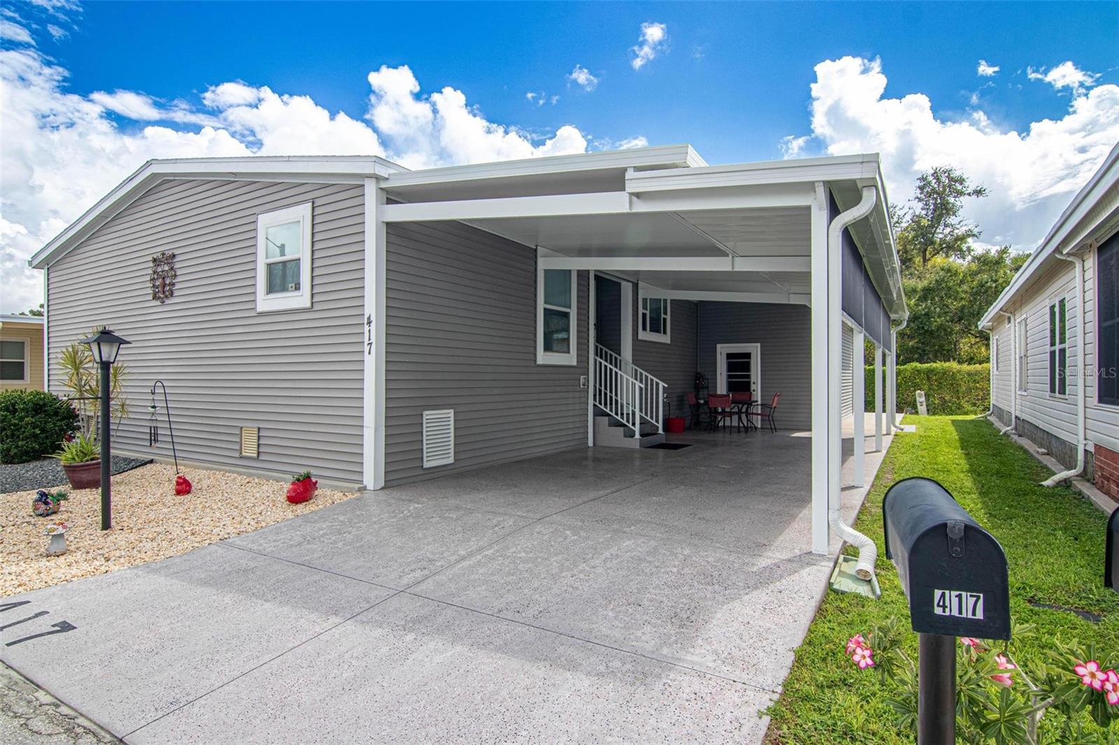 Welcome to this stunning 2018 manufactured home offering nearly 1,800 sq ft of beautifully appointed living space. This spacious 3-bedroom residence is thoughtfully designed with comfort and accessibility in mind. Step into an open-concept layout featuring extra-large rooms, stylish furnishings, and a showstopping kitchen complete with a farm-style sink, stainless steel appliances, and an oversized bar perfect for entertaining. Beautifully designed ceilings, custom window coverings and unique lighting throughout. The master suite boasts a luxurious bathroom with dual sinks and a massive walk-in closet. Accessibility features include a chair elevator and wide, easy-to-navigate spaces. Outside, enjoy a double carport and a 10x24 storage shed connected to the house and equipped with an automatic garage door and opener. This home is a rare find—beautifully maintained, disability-equipped, and move-in ready. Don't miss out. Six Lakes is a 55+ community that offers a newer clubhouse, restaurant, tennis court, pickleball and don't forget the golf course.