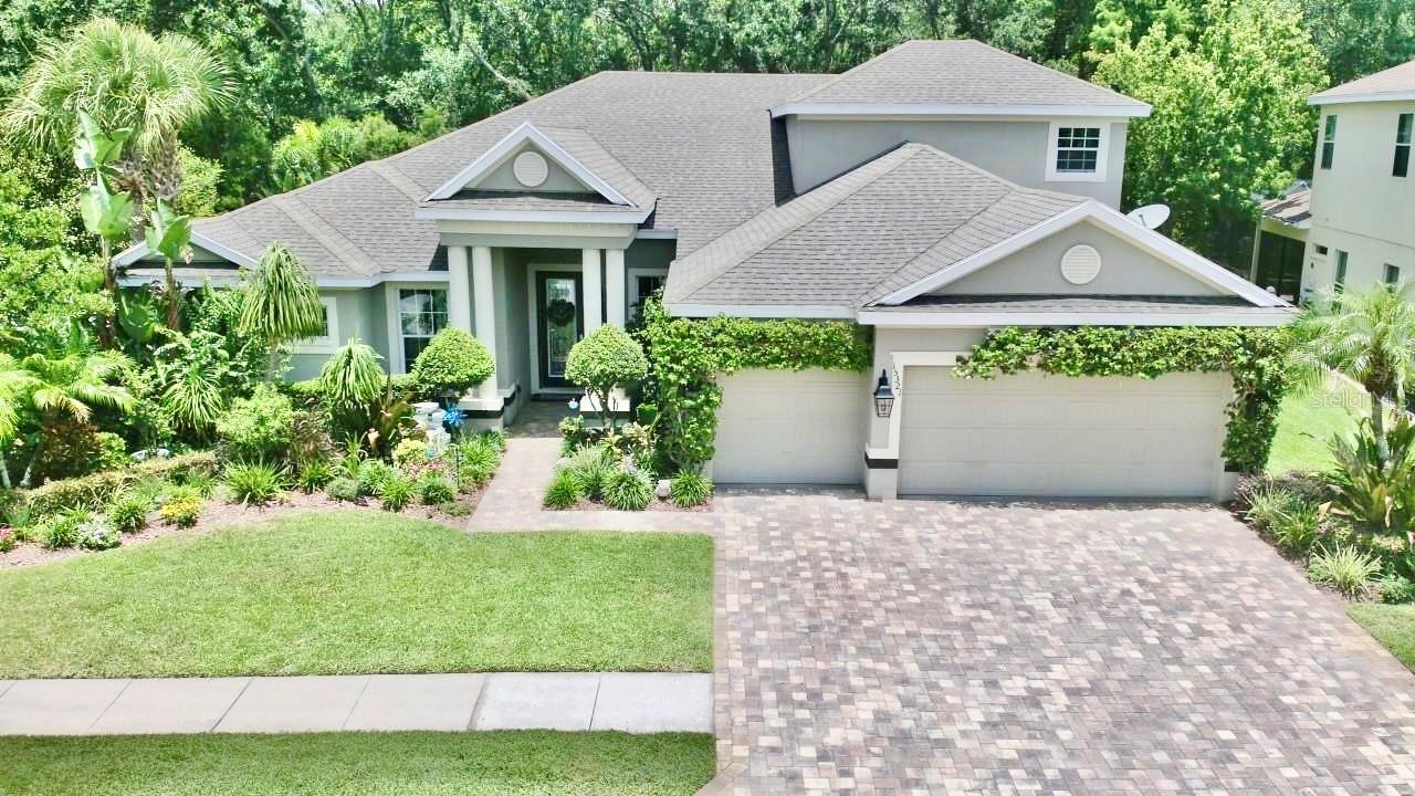 Welcome to your dream home in the prestigious gated community of Grey Hawk! This impeccably maintained, one-owner residence offers 4 bedrooms, 4 bathrooms, a 3-car garage, and a sparkling pool, all perfectly situated on a private homesite with tranquil pond views and no rear neighbors. From the moment you arrive, you'll appreciate the exceptional curb appeal, enhanced by lush tropical landscaping and a charming flowering vine that beautifully accents the garage. Every detail of this home reflects the pride of ownership, with thoughtful updates and meticulous maintenance providing peace of mind for its next owner. Step inside and experience the quality craftsmanship and elegant finishes that create a warm, luxurious atmosphere. The traditional "L" floor plan offers both privacy and functionality, with the spacious primary suite tucked away on one side of the home and the secondary bedrooms on the opposite wing. Just off the foyer, you'll find a private home office along with formal living and dining spaces, offering flexibility for entertaining or creating a billiards room or additional gathering area. Expansive windows throughout the home fill each room with an abundance of natural light, enhancing the home's bright and inviting feel. The chef-inspired kitchen is designed to impress, featuring abundant cabinetry, upgraded appliances, a center island, and a sunny breakfast nook overlooking the pool. The kitchen opens seamlessly to the spacious family room, where custom ceiling beams, a striking brick fireplace, and walls of windows create the perfect setting for relaxing or entertaining while enjoying views of the outdoor living space.The generously sized secondary bedrooms share a well-appointed hall bath, while the expansive upstairs suite with its own private bathroom offers endless possibilities. Whether you envision a media room, game room, guest retreat, home gym, or playroom, this versatile space can easily adapt to your lifestyle.The true showpiece of this home is the spectacular backyard oasis. Enjoy year-round Florida living with a beautiful screened pool and spa, covered lanai, and additional sun deck perfect for lounging or entertaining. With no rear neighbors, you'll experience exceptional privacy while taking in peaceful pond views.Homes of this caliber in Grey Hawk are highly sought after and don't stay on the market for long. Schedule your private showing today and discover everything this exceptional property has to offer!