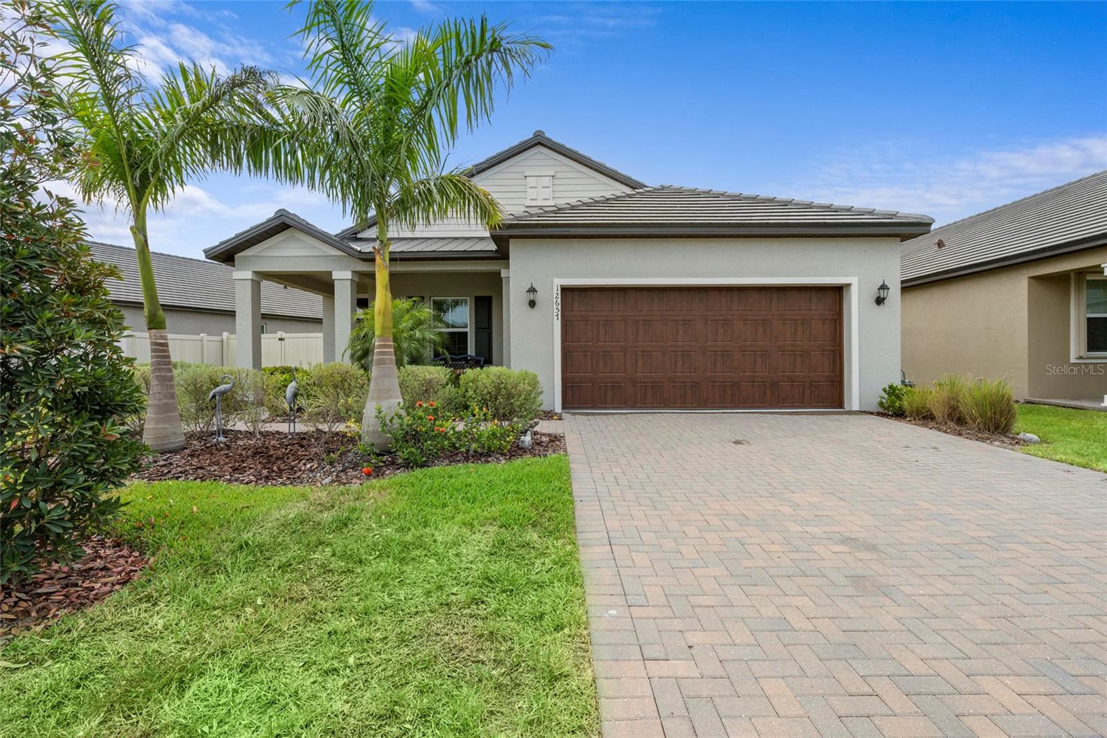 Why buy new when the Seller already put in all the upgrades!!! Welcome home to this stunning 2 bedroom, 2 bathroom single-family residence nestled in the highly sought-after 55+ section of this vibrant, amenity-rich community. From the moment you arrive, lush tropical landscaping and a charming covered entry set the tone for the coastal-inspired lifestyle that awaits inside. The open-concept floor plan is bathed in natural light, with wood-look tile flooring flowing seamlessly through the spacious great room, dining area, and into the chef-inspired kitchen. Crisp white shaker cabinets, gleaming quartz countertops, a classic subway tile backsplash, and a full suite of stainless steel appliances make this kitchen as functional as it is beautiful. The oversized island with bar seating is perfect for entertaining or casual mornings with coffee. The primary suite is a true retreat, complete with a generous walk-in closet and a spa-like ensuite featuring a dual-sink vanity and a walk-in shower. A well-appointed second bedroom and full guest bath offers comfortable accommodations for visitors. A versatile flex room provides the perfect space for a home office, hobby room, or additional guest suite. Step through the sliding glass doors to your screened lanai, where serene pond views and a beautifully landscaped, fully fenced backyard create a peaceful outdoor sanctuary ideal for morning coffee, evening gatherings, or simply soaking in the Florida sunshine. As a resident of the dedicated 55+ section, you'll enjoy exclusive access to a full-service kitchen and bar, yoga studio, and tailored social programming. The community's exceptional shared amenities elevate everyday living with a resort-style pool with waterslides, pickleball, tennis, bocce ball courts, a state-of-the-art fitness center, and a welcoming clubhouse. Outdoor enthusiasts will love the scenic walking trails, access to nearby golf, and dedicated dog parks because your four-legged family members are welcome here too.
This is Florida living at its finest  don't miss your opportunity to call it home.