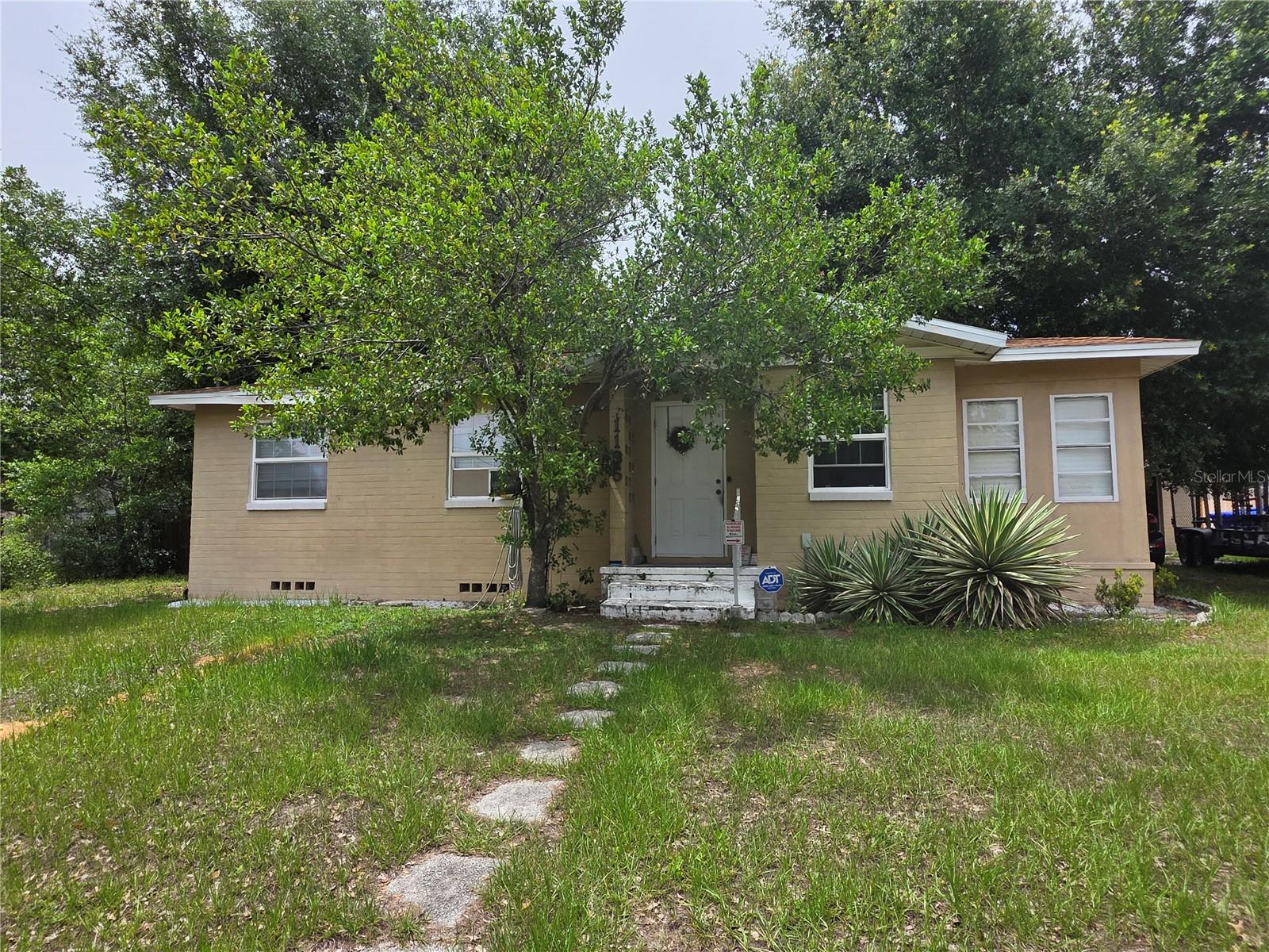 SELLER IS OFFERING $5,000 IN CREDITS TOWARDS BUYER'S CLOSING COSTS AND PRE-PAIDS! Enjoy being just minutes from Bonnet Springs Park, Lake Hunter, downtown Lakeland's restaurants, shops, and events, Lakeland Regional Health, and many of the area's most popular attractions and amenities. Convenient access to I-4 makes commuting to Tampa or Orlando easy while still enjoying the peaceful atmosphere of a historic neighborhood. Nestled in Lakeland's sought-after Sunnymeade Historic District near Lake Hunter, this charming 3-bedroom, 1-bath home offers timeless character, solid construction, and an exceptional location on a spacious double lot totaling approximately 0.31 acres. Situated on a picturesque brick street accented by historic-style street lighting, this property captures the unique charm that makes Lakeland's historic neighborhoods so desirable. Mature oak trees provide shade and curb appeal, while the expansive, fenced backyard offers plenty of room for entertaining, gardening, pets, or future possibilities.
Built in 1952, this solid block home features original hardwood floors, a bright sunroom filled with natural light, and the warmth and character of classic Florida living. Four window units and a stand alone portable a/c unit keep this home nice and cold! The detached 20' x 20' garage provides ample space for parking, storage, hobbies, or a workshop. Additional features include a paver patio area, natural gas service with a gas water heater, and an updated PEX water line from the street to the home.  Offering strong bones, original character, generous outdoor space, and a location that is difficult to replicate, this home presents an excellent opportunity for buyers seeking charm, convenience, and value. No HOA or CDD fees.