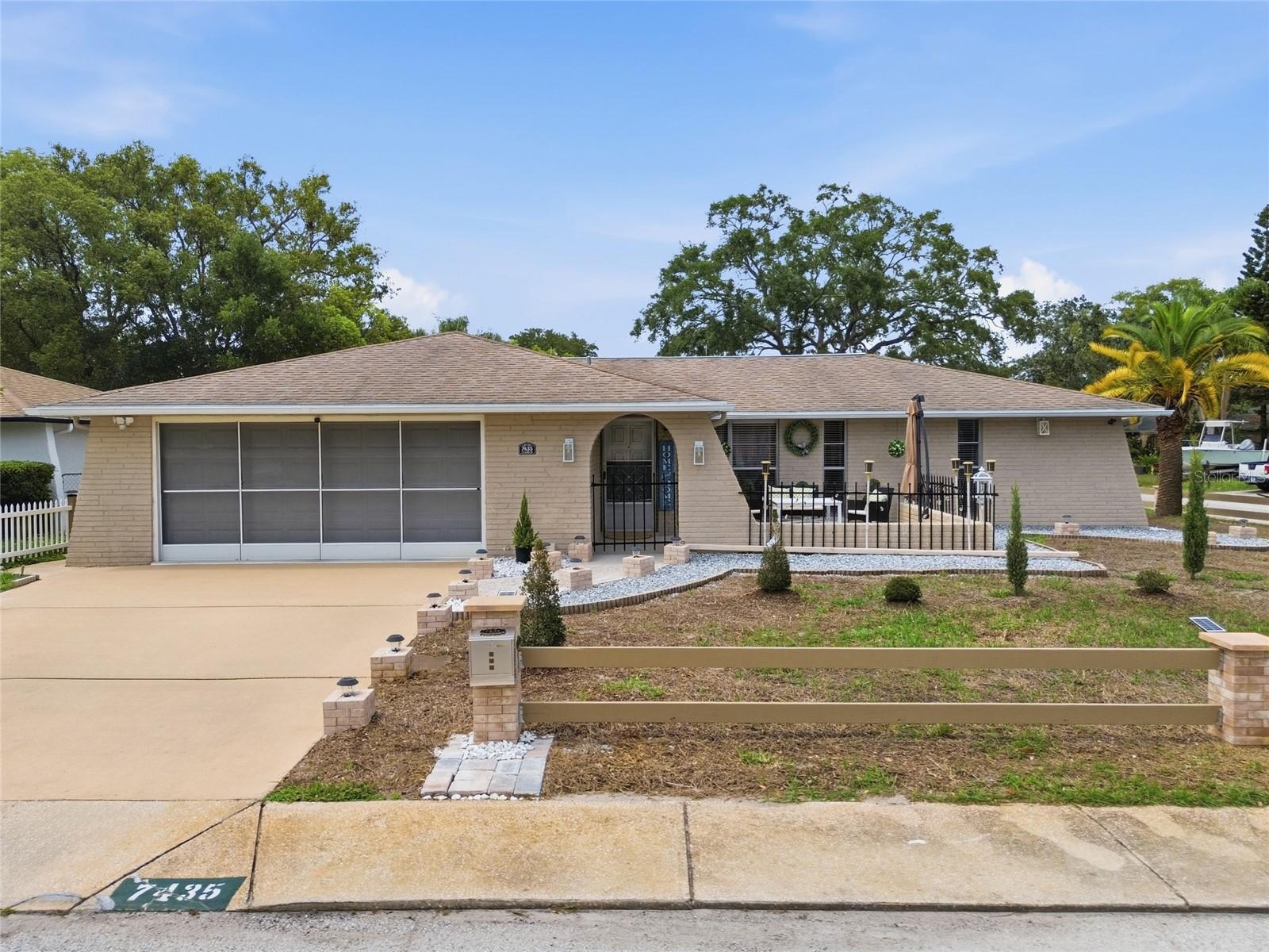 Welcome home to this beautifully maintained 2-bedroom, 2-bath residence situated on a desirable corner lot. From the moment you arrive, you’ll notice the inviting curb appeal, decorative fencing, spacious driveway, mature landscaping, and charming front courtyard perfect for relaxing or entertaining.

Inside, the home offers a bright and comfortable layout with neutral paint tones, updated flooring in the main living areas, stylish lighting, and an electric fireplace that adds warmth to the living space. The living and dining areas flow into the kitchen, which features stainless steel appliances, ample cabinet space, solid surface countertops, and a breakfast bar.

The primary bedroom offers great natural light and a comfortable retreat, while the additional bedroom provides flexibility for guests, an office, or hobby space. Enjoy Florida living from the outdoor patio area and screened/enclosed rear space.

Conveniently located near shopping, dining, medical facilities, parks, and Gulf Coast beaches. A well-kept home with great indoor and outdoor living spaces,schedule your private showing today!