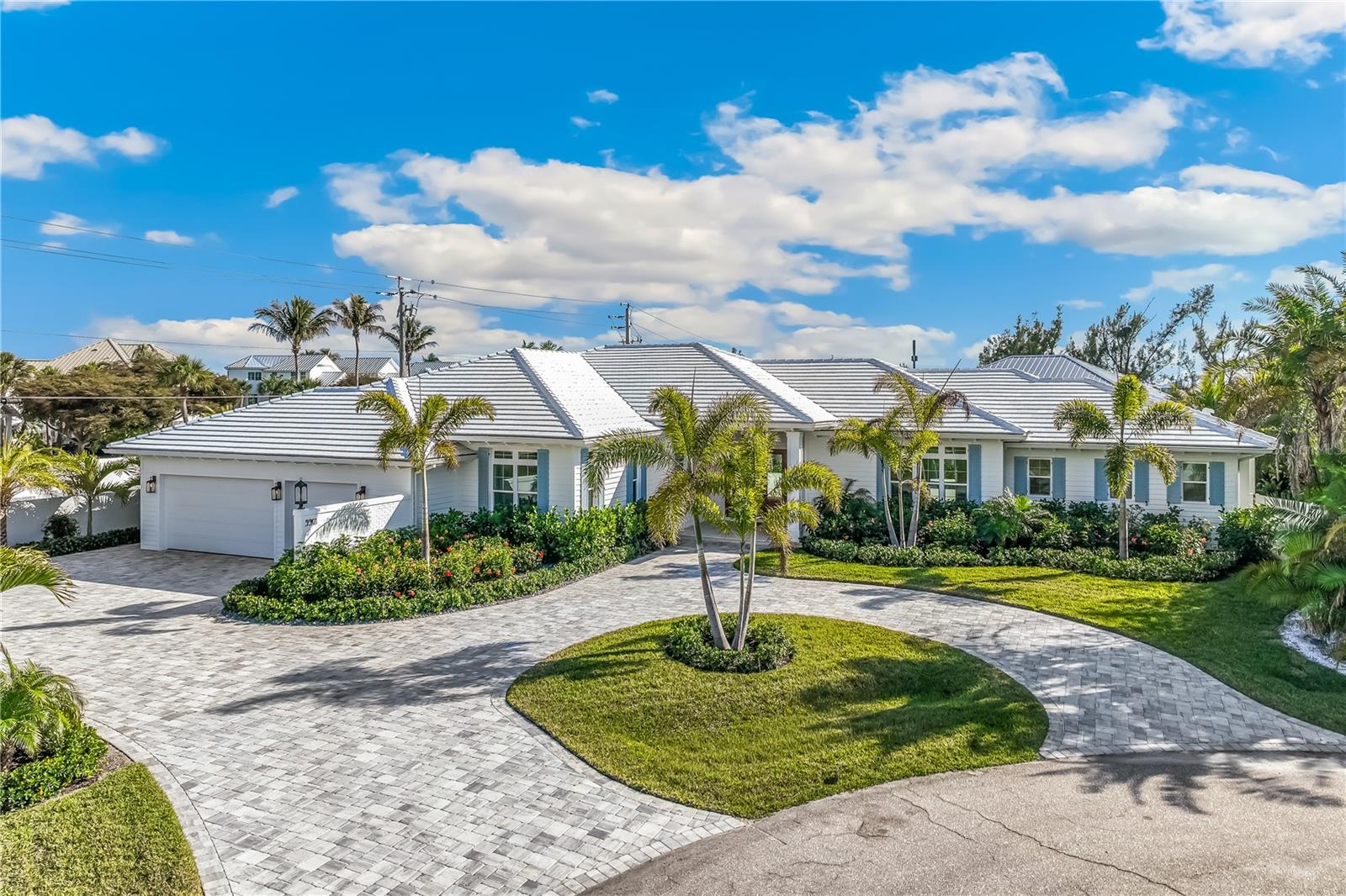 One or more photo(s) has been virtually staged. Modern Coastal Luxury - NEW HOME - Just Completed! Discover one of Boca Grande’s newest and most exclusive homes on the prestigious North Shore of Gasparilla Island. This brand-new 5-bedroom, 5-bathroom estate (each bedroom featuring en-suite bathrooms) offers over 4,000+ sq. ft. designed for effortless coastal entertaining on one level. Set at the end of a private living cul-de-sac and positioned on one of the highest elevated lots on the island, the property is surrounded by masonry privacy walls and features professionally designed lush tropical landscaping. Once inside, you’ll find soaring ceilings, custom millwork, 7.5” white oak flooring, and impact-rated sliders that blend indoor and outdoor living. A unique zero-post sliding glass door system leads to an expansive covered lanai (600+ sq. ft.) featuring a retractable Phantom Screen, custom outdoor kitchen with Coyote appliances, while overlooking the elegantly designed pool and spa. The home is an entertainer's dream featuring a chef’s inspired kitchen complete with designer cabinetry, Thermador appliances, extra-large workstation sink, dual dishwashers, quartz countertops, and a 12' center island perfect for hosting. Additional highlights include a wet bar and prep area coupled with a wine chiller tower, beverage center, spacious walk-in pantry, and discreet mudroom/laundry area. The primary suite is thoughtfully designed offering a majestic view of the pool and backyard with separate walk-in closets. The primary bathroom is a serene retreat offering heated floors, an oversized shower and soaking tub, along with custom Robern medicine cabinets and designer lighting. The additional en-suite bathrooms offer their own privacy and Bedroom 2 can also serve as a den or office if desired. Guest suite bathrooms provide private comfort with curbless walk-in showers and custom designer finishes throughout. Designed by nationally recognized T.A. Krebs Architects, and crafted by preferred island builder L.J. Silva Construction, this 2025 masterpiece combines masonry block construction with energy-efficient spray foam insulation, premium concrete tile roofing, "cool touch" Shellock pool and lanai pavers, and a 24 kW Generac generator. With an attached 3-car garage, the home has ample storage for your Moke or golf cart and other outdoor island toys. Smart home technology includes an app-controlled pool/spa & fireplace lighting, irrigation, sound pre-wiring throughout and a 75" Samsung Frame Pro TV in the family room. Deeded beach access is just steps away and ownership boat dockage with lift capability (up to 65') is just across the road, for easy and quick access if desired. This estate offers both tranquility and accessibility to the island’s best amenities. Along with Coral Creek Jet Center/Airport and a Tom Fazio Signature Golf Course just across the Bridge. A few photographs are virtually staged. Experience the pinnacle of Boca Grande living - modern coastal luxury at its finest.