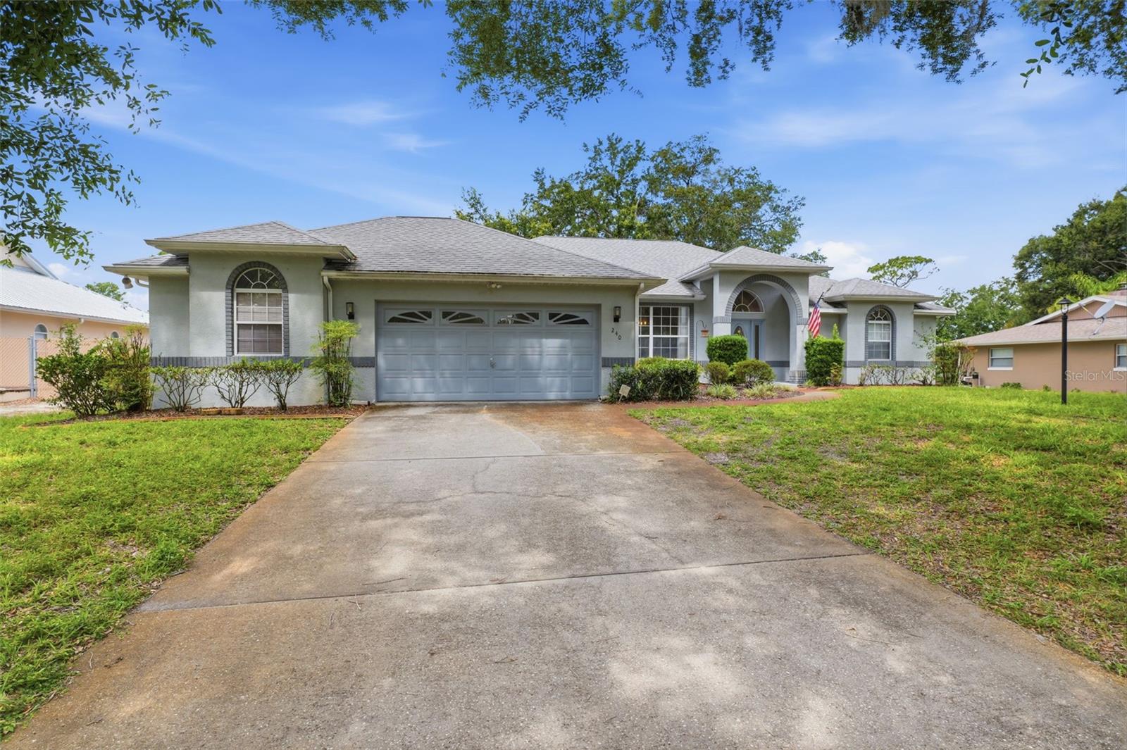 Situated on an elevated 0.34-acre lot overlooking the 13th hole of the Plantation Golf Course, this inviting 3-bedroom, 2-bath home with a 3-car garage, including a side-entry golf cart garage, offers a wonderful blend of comfort and golf course living. An arched covered entry welcomes you inside, where the foyer features tile flooring, high ceilings, and a convenient coat closet. To the left, the dining room showcases luxury vinyl flooring, which continues throughout much of the living area, along with a wide front-facing window that fills the space with natural light. Further inside, the spacious living room features cathedral ceilings and a cascading sliding glass door that opens to the sunroom, creating an easy connection between indoor and outdoor living. Centrally located, the kitchen combines functionality and style with white tile flooring, abundant white cabinetry, spacious countertops, a dual sink, stainless steel appliances, a breakfast bar, and a pantry for additional storage. Adjacent to the kitchen, the breakfast nook offers the same tile flooring, a charming bay window, and a glass-paneled door leading directly to the sunroom. The generously sized primary suite features carpet flooring, double sliding glass doors opening to the patio, a cozy sitting area framed by bay windows overlooking the backyard, and a walk-in closet leading to the en-suite bathroom. The spacious en-suite bath includes a soaking tub surrounded by white tile beneath an arched window, dual vanities with abundant cabinetry, and a separate step-in shower. Bedrooms 2 and 3 each feature carpet flooring, built-in closets, and windows that provide natural light, while an additional storage closet is conveniently located between the two rooms. The nearby guest bathroom includes a single vanity, a step-in shower with a glass enclosure, and direct access to the sunroom. The laundry room offers overhead cabinetry, built-in storage, and convenient corridor access to the garage. At the rear of the home, the bright sunroom features expansive windows overlooking the backyard and golf course, filling the space with natural light, along with a wide door leading to the brick-paver patio. Outside, the spacious patio is surrounded by mature trees and provides a peaceful setting to relax, entertain, or simply enjoy the scenic views of the Plantation Golf Course. Conveniently located in Crystal River, this home is just minutes from Plantation Resort amenities, Kings Bay, Crystal River's famous springs for kayaking, paddleboarding, boating, and manatee encounters, as well as local shopping, dining, and the Gulf Coast's outdoor recreation.