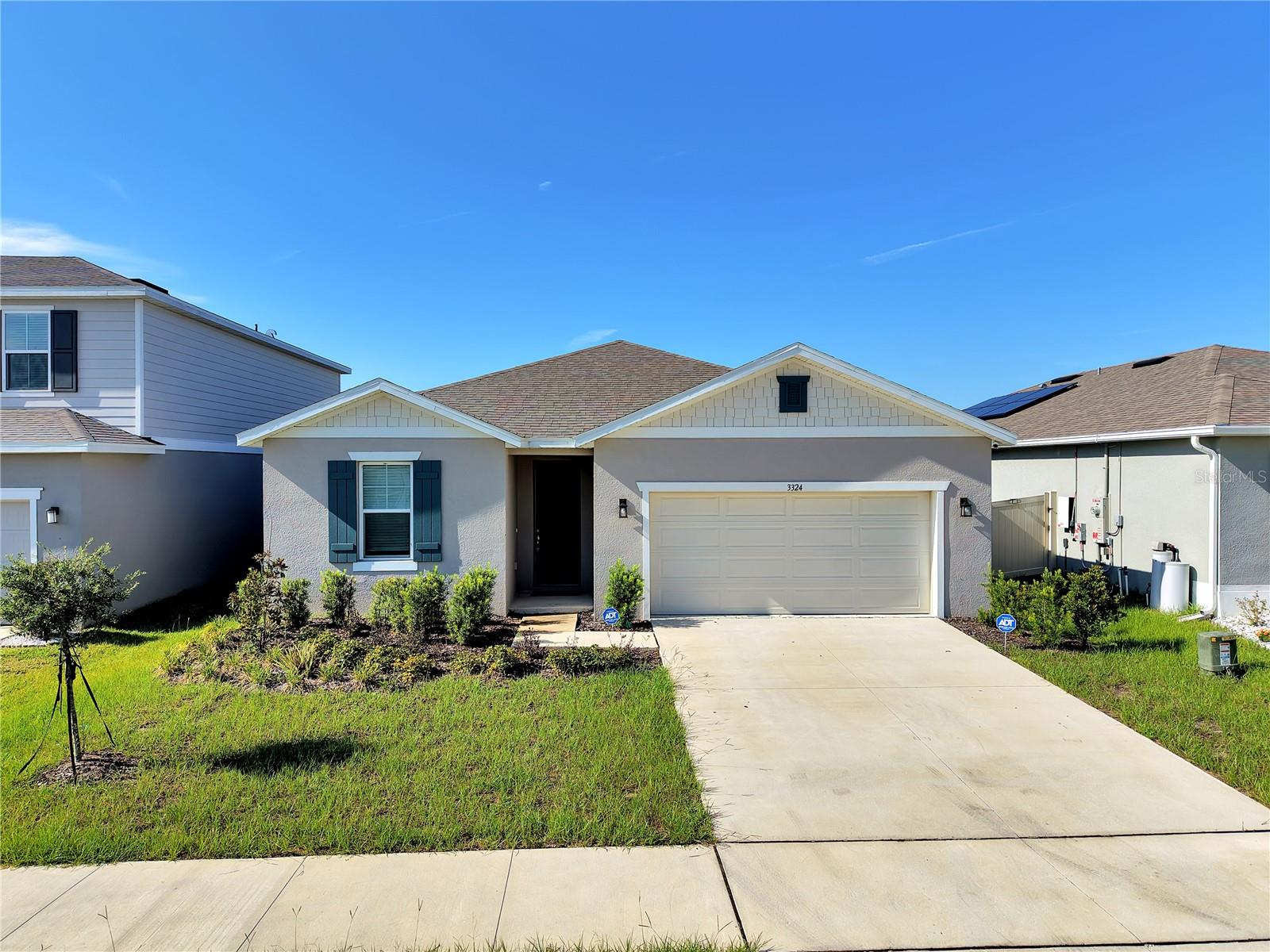 Welcome to Scenic Terrace in Lake Hamilton, conveniently located near Haines City with quick access to Highway 27 and just minutes from Port 27. Built in 2024, this move-in ready 4-bedroom, 3-bath home offers an open-concept floor plan with high ceilings, luxury tile flooring throughout the main living areas, and carpet in the bedrooms. A rare feature of this home is its two primary suites, each with its own en-suite bathroom, providing added flexibility for multigenerational living, guests, or roommates. The main primary suite enjoys peaceful backyard views, a large walk-in closet, and an en-suite bath with dual vanities, a soaking tub, separate walk-in shower, and private water closet. The spacious kitchen features matching stainless steel appliances, ample cabinetry, and overlooks the living and dining areas, creating an ideal space for everyday living and entertaining. Additional features include an interior laundry room with washer and dryer, whole-house water softener, smart ceiling fans, a screened patio, a partially fenced backyard with no rear neighbors and open green space behind the home, and an attached 2-car garage with driveway parking. For added peace of mind, the refrigerator water filter and A/C filter have both been recently replaced. Residents enjoy access to a resort-style community pool and playground. Renters insurance is required.