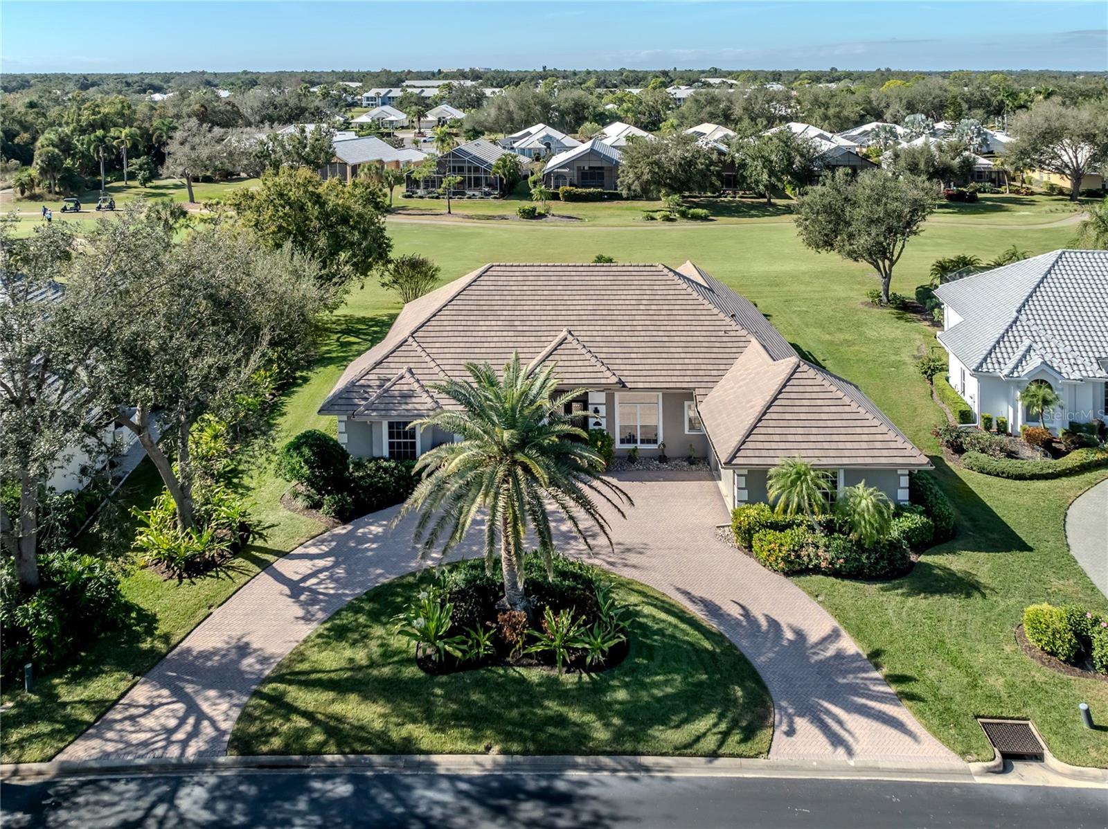 Behind the exclusive gates of The Reserve in Plantation, an enclave of just 73 estate-style homes, this distinguished 3-bedroom, 3-bath executive home offers refined living in one of Venice’s most desirable communities. Perfectly positioned on hole two of the Panther Golf Course, the property enjoys tranquil fairway vistas and an exceptional sense of privacy and serenity. Thoughtfully updated for peace of mind, the home boasts a new roof, hurricane-protected windows and sliding glass doors, ensuring beauty and protection in every season. Step outside to an expansive screened lanai designed for effortless Florida living. Attractive pavers frame a sparkling, oversized pool, while a retractable awning provides shade at the touch of a button, ideal for both lively gatherings and quiet afternoons enjoying the view. Inside, the residence impresses with timeless style and modern comfort. The gourmet kitchen is a chef’s dream, featuring a triple-basin stainless sink, stunning quartzite countertops, a spacious center island, and high-end finishes that elevate everyday living. Multiple living and entertaining spaces include a formal living room, formal dining room, and a warm, inviting family room highlighted by a cozy gas fireplace. A dedicated den with custom built-in bookcases and desk makes the perfect home office or study, offering a quiet retreat for work or creativity. Additional features include an interior laundry room, a two-car garage, and a circular driveway that enhances both convenience and curb appeal. Surrounded by lush, meticulously maintained landscaping, this home blends comfort, craftsmanship, and luxury, inside and out. Discover an exceptional lifestyle in a prestigious golf course setting, just minutes from Venice’s beaches, dining, and amenities, with low HOA fees and no CDD fees. Membership at the privately owned Plantation Golf & Country Club is optional. Residents who join can enjoy two championship 18-hole golf courses designed by Ron Garl, multiple dining venues, banquet facilities, 12 Har-Tru tennis courts, a fitness center, and a Junior Olympic–sized pool. The location is outstanding, just 5 minutes to Wellen Park, with its shopping, dining, entertainment, and the Atlanta Braves spring training ballpark; 15 minutes to the Island of Venice and to beautiful Gulf beaches; and 10 minutes to I-75 for easy travel to Sarasota, Fort Myers, Tampa, and major airports. The community also sits close to cultural events, theaters, and miles of stunning coastline that make Venice world-renowned.