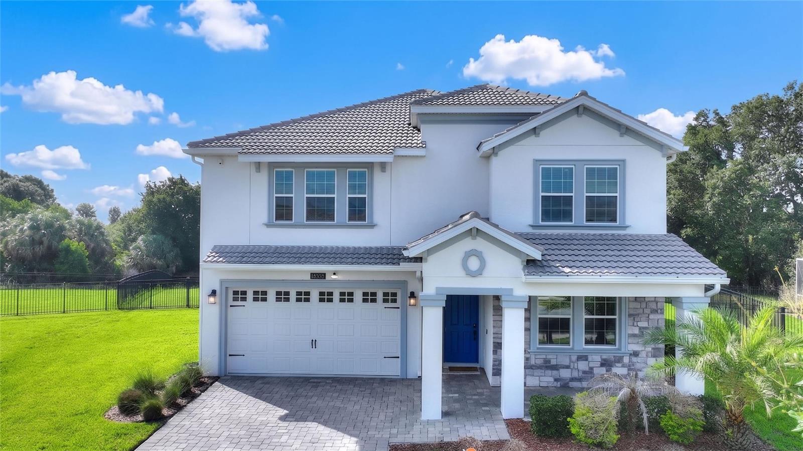 YOUR SEARCH IS OVER! This is the home you have been looking for! Welcome to 1455 Olympic Club Boulevard in the highly sought-after ChampionsGate Country Club, where luxury living meets world-class resort amenities! This impressive Nicholas model offers 3,949 square feet of thoughtfully designed living space with 5 bedrooms, 4.5 bathrooms, perfectly placed on an oversized fenced conservation homesite that provides both privacy and beautiful nature views.

Designed with today's lifestyle in mind, this spacious open-concept floor plan offers room for everyone. Enjoy the flexibility of two primary suites, one located on the main floor and one located on the second floor. As if it couldn't get better than that you will also find  a private junior suite on the second floor. Two additional bedrooms share another full bathroom, while convenient laundry facilities are located on both levels for easier living The home also features both a downstairs family room and an upstairs bonus/family room, making it ideal for multi-generational living, entertaining, or creating separate spaces for work and play. 

The oversized three-car tandem garage provides ample space for multiple vehicles, a golf cart and plenty of storage.

Ownership includes one of the finest HOA packages in Central Florida, featuring a full golf membership, complete landscaping and weed prevention, guard-gated security with roaming patrol, and the Platinum Package for your cable, internet, and phone that includes premium channels, food and beverage discounts and credits at all of the restaurants and pro-shop.

Residents enjoy exclusive access to multiple amenity centers, including the homeowners-only Plaza Amenity Center, featuring upper and lower resort pools, fitness center, sauna, pickleball courts, putting green, billiards room, ping pong, and a $75 monthly food and beverage credit. Homeowners also receive 20% discounts at the Golf Club Grill, Pro Shop, Oasis Club, and Retreat Club.

The renowned Oasis Club offers a lazy river, resort-style pool, hot tub, fitness center, mini arcade, private movie theater, children's splash area, sand volleyball, indoor and outdoor dining, and air-conditioned cabanas. The Retreat Club features two exciting water slides, another resort pool, miniature golf, playground, outdoor dining, and relaxing hammocks. For those seeking a quieter setting, the North Pool offers a peaceful pool, playground, bocce ball courts, and shaded picnic areas this pool is located in the North Country Club is reserved exclusively for homeowners.

Conveniently located just minutes from I-4, world-famous theme parks, shopping, dining, golf, and Orlando International Airport, this exceptional home offers the perfect combination of luxury, space, privacy, and an unmatched country club and resort lifestyles.

Don't miss this rare opportunity to own one of ChampionsGate Country Club's most desirable floor plans on an oversized conservation homesite!