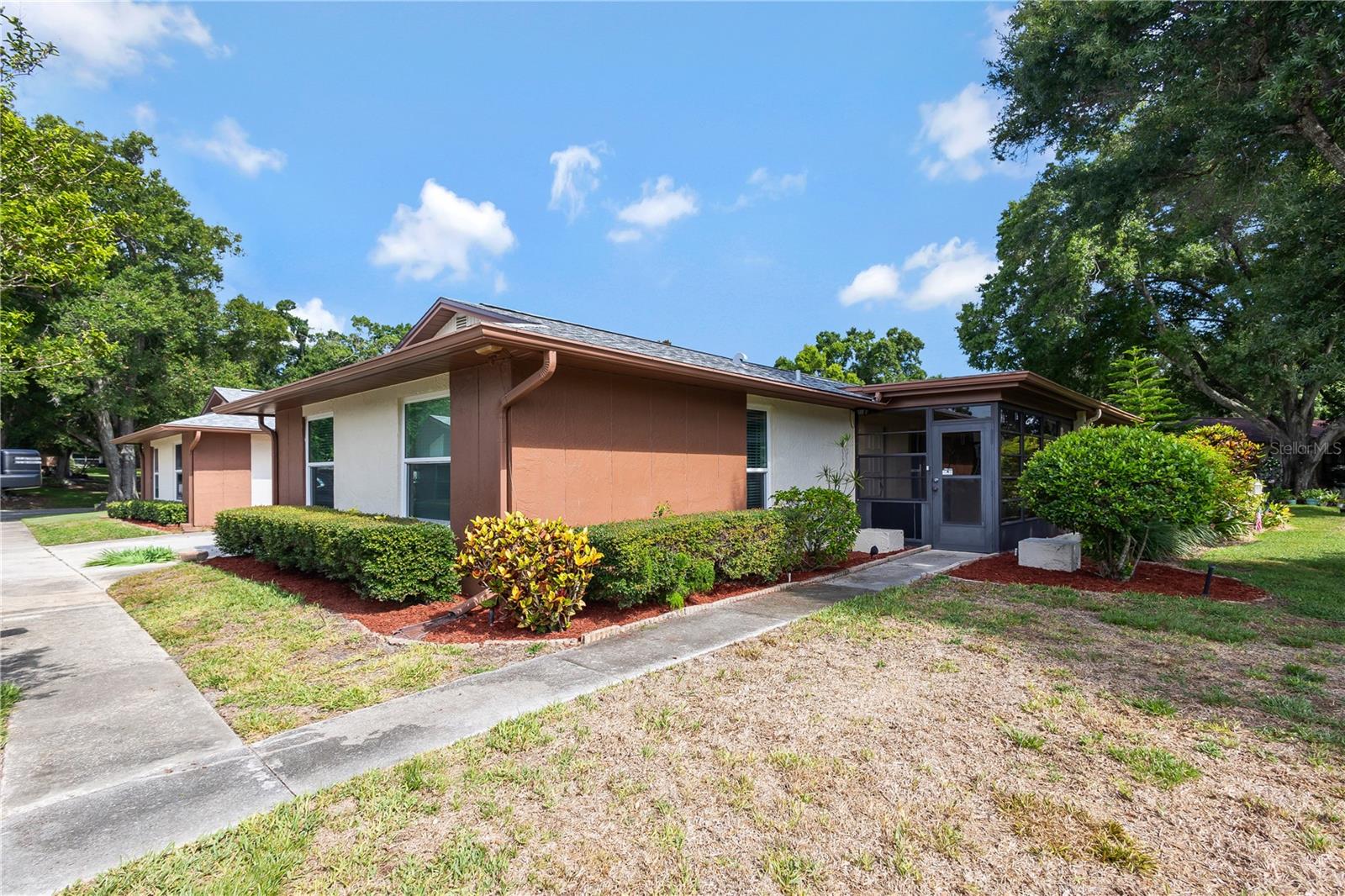 Virtually Staged. Rare Corner-Unit in the highly sought-after Highland Lakes Active 55+ Community. This spacious 2-Bedroom, 2 Bath Villa offers the privacy, and natural light buyers love with corner units. Enjoy a bright, open layout, attached 1-Car Garage with an Open-Concept layout featuring a spacious living room and a cozy dining area perfect for entertaining. Primary bedroom has a walk-in closet and ensuite bathroom. The second bedroom has a built-in closet and oversized window allowing natural light to brighten the room.  Resort-style living meets everyday comfort! This beautifully maintained single-story villa offers a low-maintenance lifestyle with all the amenities you've been dreaming of including: - 27-hole executive golf course (no green fees!), Heated pool & spa, Tennis, pickleball, and shuffleboard courts, Clubhouse with fitness center, arts & crafts, and social events, Private boat access to Lake Tarpon located just minutes from Honeymoon Island, top-rated medical facilities, and shopping. This home offers the perfect blend of peaceful living and vibrant community life. Move in and rest assured that the big-ticket items have already been replaced. HVAC 2020, Updated Electrical Panel 2020, Hurricane Impact Windows replaced 2022. Unit seats High and Dry, NON-Evacuation Zone and Non-Flood Zone. Private entrance, low foot traffic, and great views of the open green space outside your porch makes this corner unit the perfect match for your next chapter. Schedule your private tour today and discover why so many are choosing the Highland Lakes Lifestyle!