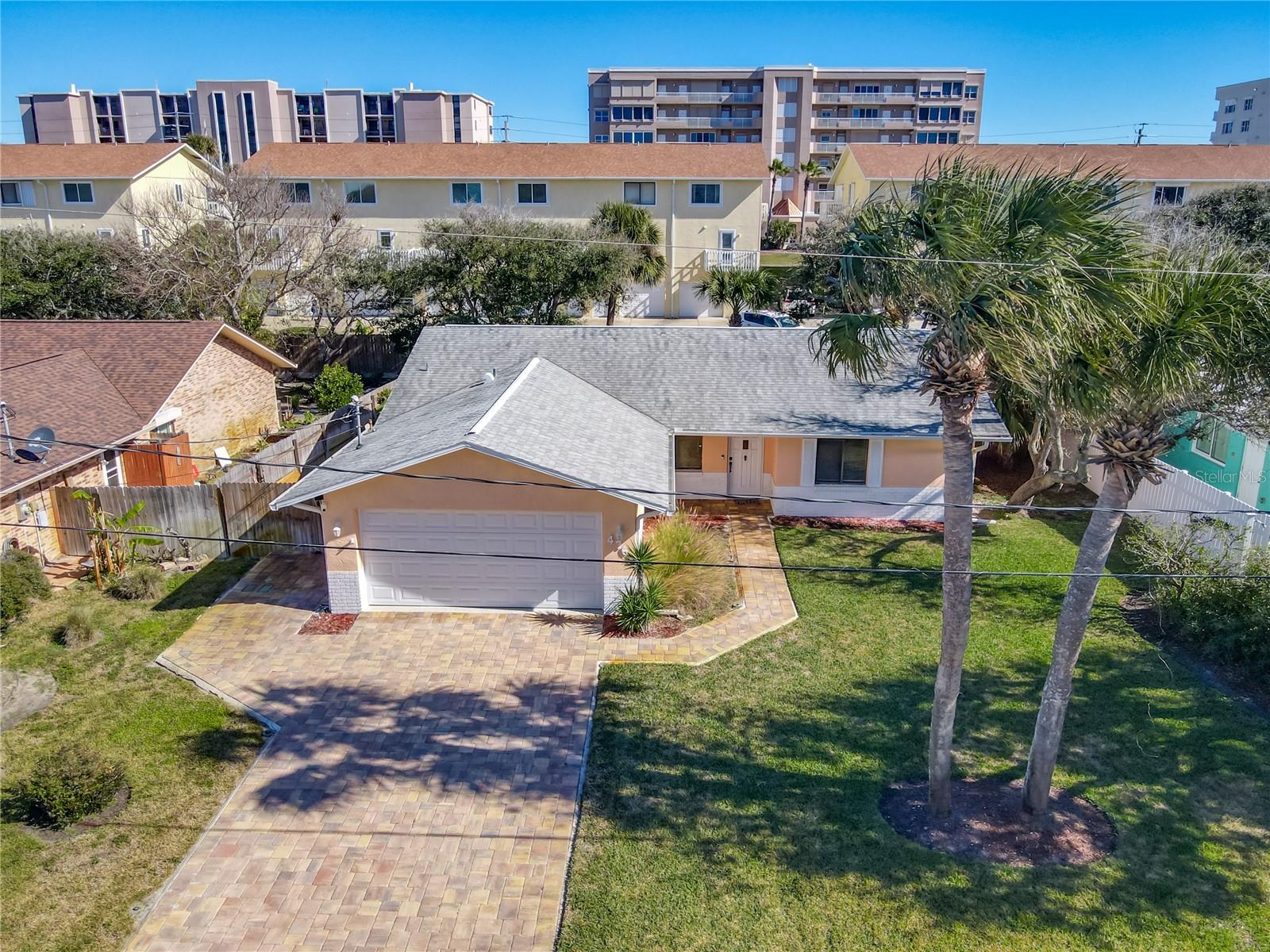 Imagine waking up and taking a short, breezy stroll to the beach before the rest of the world is even awake. That's the kind of effortless coastal lifestyle waiting for you at this beautifully updated Ponce Inlet ranch. From the moment you walk through the door, the vaulted ceilings and incredible natural light create a space that feels open, airy, and instantly like home. If you love to host, the heart of this house is where you'll spend all your time. The modern kitchen is a showstopper with its solid stone countertops, and it overlooks the main living area so you can stay connected with friends and family while you're prepping a meal. When you're ready to wind down, the primary suite acts as your own private sanctuary, complete with a beautifully updated ensuite that feels like a daily getaway. Even your guests will feel spoiled with their own generous walk-in closets. The outside is just as impressive and built for real life. You'll love the polished look of the paver driveway, with epoxy floor in the garage plus an upgraded garage door.  Evenings are to be enjoyed with the screened porch bringing the outside in with the sliding door opened to feel and smell the delightful ocean breezes. Best priced home in a coveted  lifestyle town you don't want to miss out on! Ponce Inlet is where you will love owning  a  home. Ponce Inlet is, where the beach  life is a "Lifestyle"