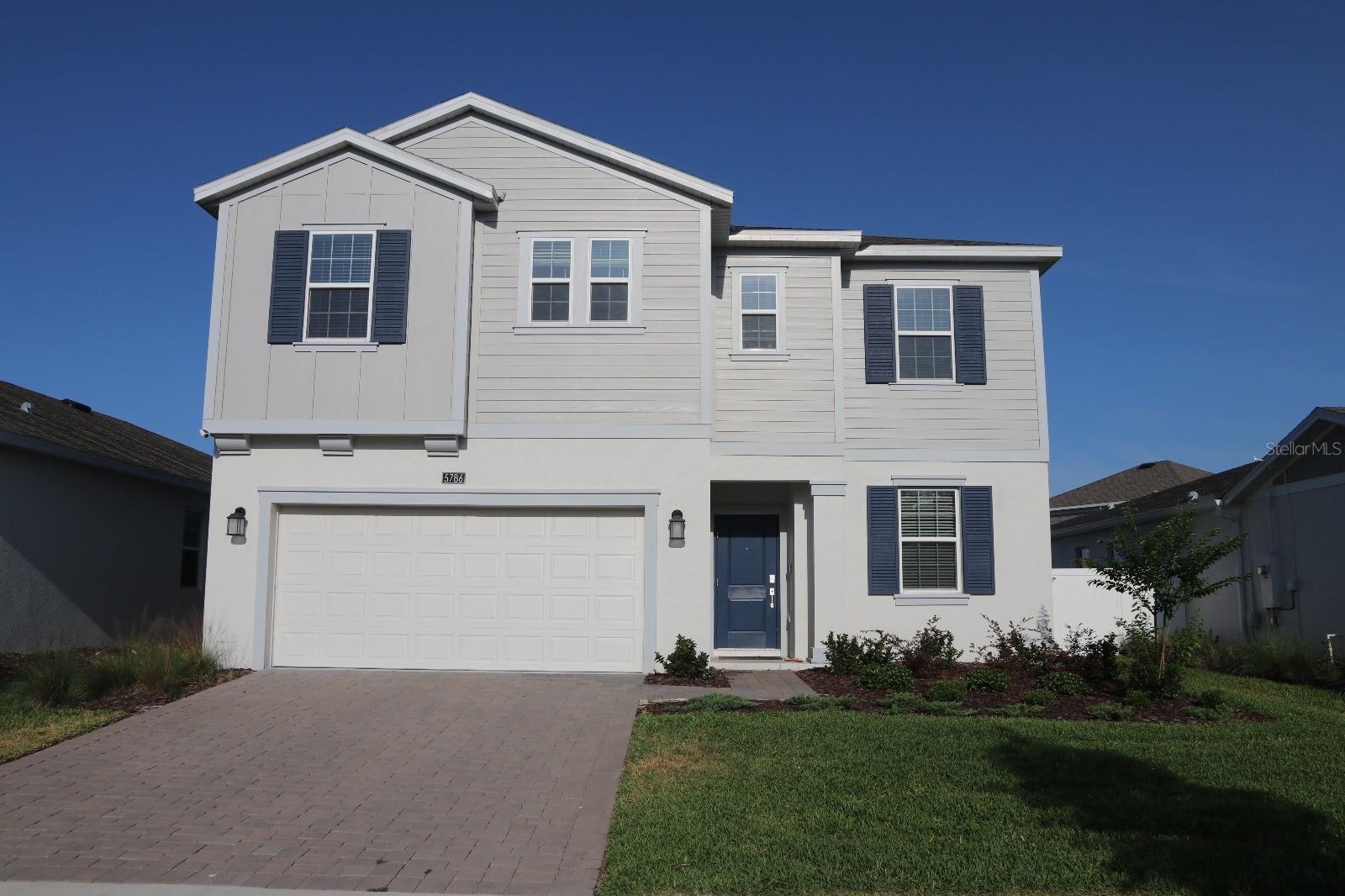 This spacious two-story home offers five bedrooms, three bathrooms, and a two-car garage. Designed with an open-concept layout, it seamlessly connects the family room, dining area, and a contemporary kitchen featuring a center island and walk-in pantry. The first floor also includes a flexible room ideal for an office or playroom, a bedroom with a full bath — perfect for guests — and a large screened lanai for enjoying outdoor living in comfort. Upstairs, the private owner’s suite provides a luxurious retreat with a spacious walk-in closet and a beautifully appointed bath with an oversized shower. Two additional bedrooms, another full bathroom, a versatile bonus room, and a conveniently located laundry room complete the second floor. Every home comes with Lennar’s signature Everything’s Included® package, which means you’ll enjoy premium finishes like quartz countertops, stylish blinds, and a full suite of stainless steel appliances — all included in the price. Plus, advanced home automation features like keyless entry and video doorbells are part of the Connected Home by Lennar®. Located in the highly sought-after Bridge Walk community, residents can indulge in a host of resort-style amenities, including a luxurious swimming pool, a modern clubhouse with a top-tier fitness center, playgrounds, and basketball and volleyball courts — all just minutes from the scenic shores of Lake Ajay.