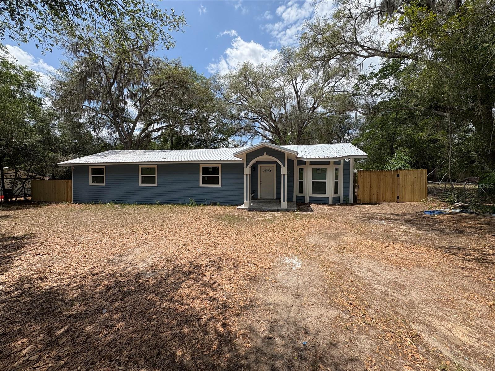 Welcome to this beautifully renovated 4-bedroom, 3-bath home situated on a generous 0.38-acre lot at the end of a quiet, one-entry street, offering privacy and minimal traffic. Completely move-in ready, this home features stylish wood-look laminate flooring throughout, fresh interior paint, a durable metal roof, a new water heater, and tastefully updated bathrooms.

The modern kitchen has been fully renovated and is equipped with stainless steel appliances, updated cabinetry, and ample counter space, making it perfect for both everyday living and entertaining. The spacious layout provides flexibility for families, guests, or a home office setup.

Step outside to enjoy the large backyard, fully enclosed with a new wood privacy fence, offering plenty of room for pets, play, gardening, or future outdoor amenities.

Conveniently located just 5 minutes from Newnans Lake, 10 minutes from downtown Gainesville, University of Florida, and the downtown campus of Santa Fe College. You'll also enjoy easy access to the Gainesville Regional Airport, located approximately 15 minutes away.

Combining modern upgrades, a spacious lot, and an excellent location close to shopping, dining, recreation, and major educational institutions, this exceptional property is ready for its next owner. Don't miss this rare opportunity to own a fully renovated home in one of Gainesville's most convenient locations.