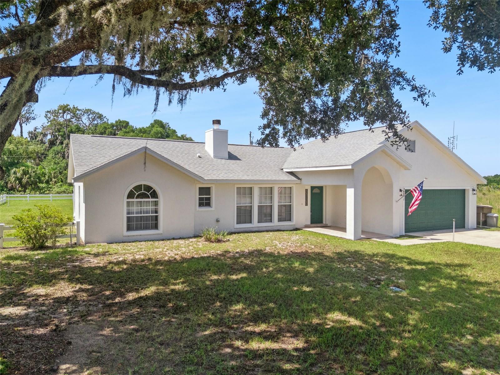 Under contract-accepting backup offers. Welcome home to this charming 3-bedroom, 2-bath residence nestled in a peaceful country setting (no HOA!), offering the perfect blend of comfort and privacy, yet is still just minutes to downtown Umatilla. Situated on a spacious .34-acre lot, this light-filled home features vaulted ceilings and an open-concept floor plan that creates an inviting atmosphere for everyday living and entertaining. Bring your boat, your RV, whatever toy you have because there’s NO HOA to deal with! Enjoy peace of mind with a newer roof (2020), newer water heater (2023), and a NEWER AC (2024). The spacious primary suite features elegant tray ceilings, private French doors leading to the screened porch, and an en-suite bath featuring a generously sized walk-in shower. Step outside to your private screened porch, where you can relax and enjoy the tranquil surroundings with no rear neighbors. The property also features a fireplace in the family room, CITY WATER, generous kitchen counter space, a slightly oversized garage, an INSIDE LAUNDRY ROOM with a convenient deep utility sink, and a storage shed (with power) that’s perfect for tools, lawn equipment, or additional storage. If you’re looking for a move-in-ready home that offers modern updates, privacy, and the serenity of country living, this one is a must-see!