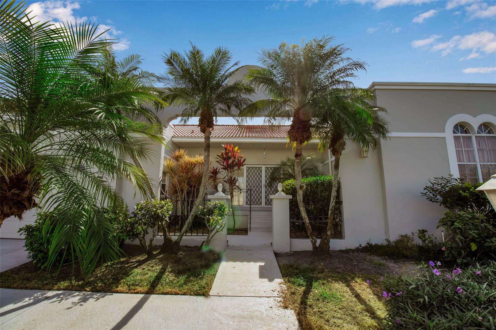 Virtually Staged. Amazing price drop! Don't miss out on this spacious villa with private pool near IMG Golf and Country Club!  Rare opportunity to own one of the largest floor plans in Palm Court.  This 2 bedroom (possibly 3 bedroom) with a den, 2.5 bath villa offers exceptional space, a private pool, and outstanding potential in a highly desirable location.  This home is in great overall condition and simply needs updating to suit your own style, making it an ideal opportunity for buyers looking to add value.  The layout includes a versatile den with fireplace that easily can function as a third bedroom or office.  Step outside to your private pool, recently upgraded with Pebble Tec finish and a new pool pump in 2023. You will also love the spacious 2 car garage.  A huge plus is the brand new roof that was just put on in 2025.  Other upgrades include new fence in 2025 and water heater in 2023.  Located just minutes from IMG Academy, golf, dining, SRQ Airport, shopping and the gorgeous gulf beaches found on Anna Maria Island!  A great place to call home or invest-bring your vision and make it your own! *Must own 2 years prior to renting