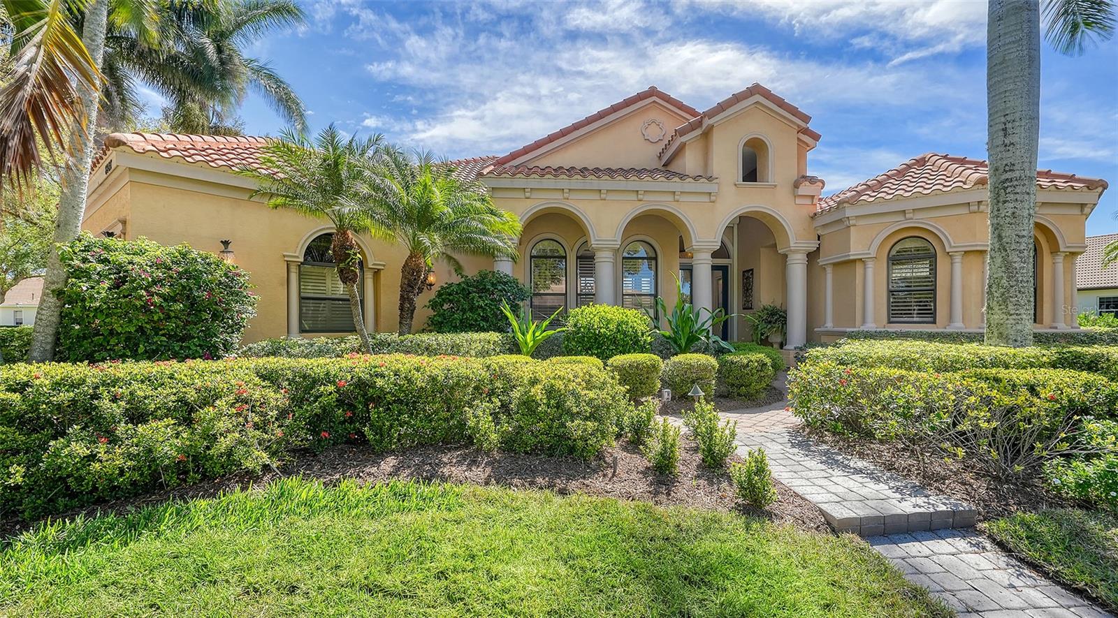 One of the finest homes ever built by Todd Johnston in popular Silver Oak. This custom designed executive home boast over 5,000 sq. ft. of architectural elegance. 4 generous bedrooms & 4.5 baths. As you enter you will be amazed at the dramatic elevated ceilings. 10ft. sliders lead you to the pool area with tranquil lake views & 2 story cage. A recently added spiral stair case leads you to a second floor balcony. Very generous first floor master bedroom  features his & her bathrooms, walk-in closets & jacuzzi. Main floor features 3 bedrooms plus an office/den. Recently remodeled gourmet kitchen. Heated pool & spa with  remodeled out-door kitchen for your enjoyment. Upstairs features large bonus/theater room, 4th bedroom & bath, built-in bar & a walk around balcony. New main AC. New tankless hot water heater. 2 yr. old pool pump & heater. Living room with gas fireplace. The sellers have recently invested $130,000 in upgrade renovations. The roof has been recently inspected & any deficiencies were expertly corrected. Located on  a double corner lake lot, nearly 1/2 acre. Silver Oak is located on Palmer Ranch close to shopping, Legacy Trail & minutes to world famous Siesta Key Beach. All homes in Silver Oak were built by Sarasota's highest rated custom home builders.