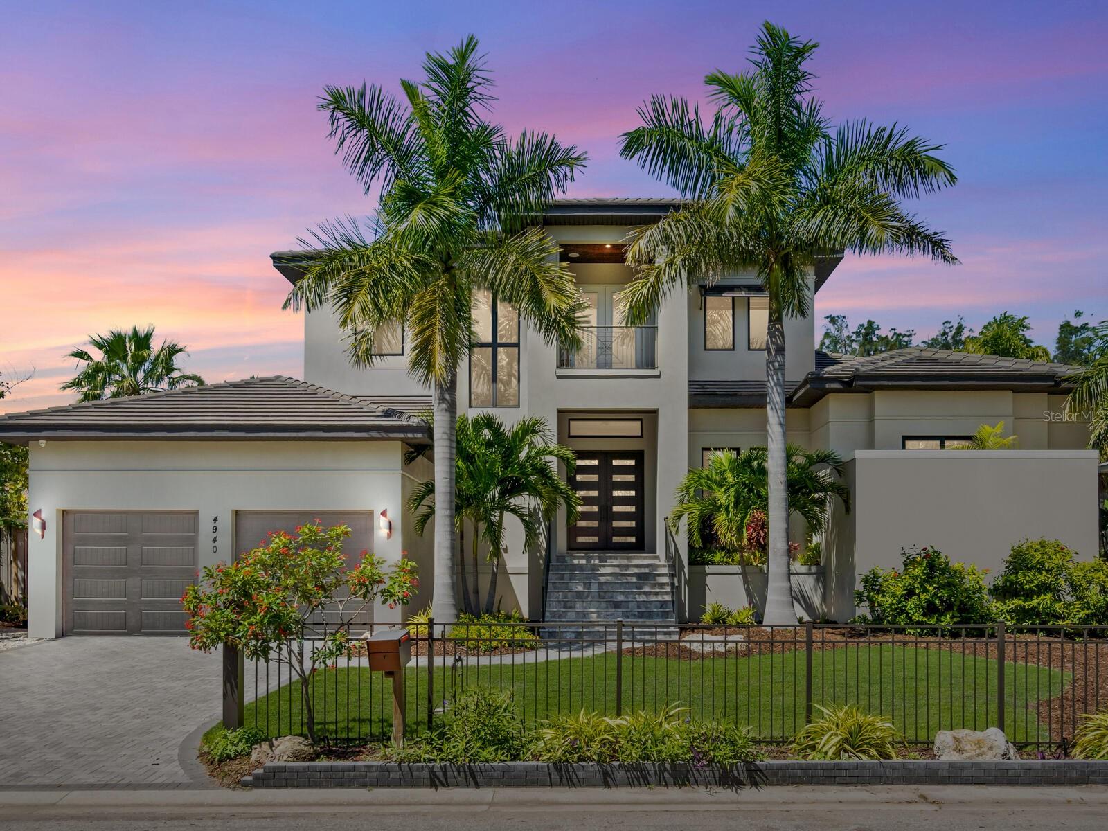 New price! Experience the epitome of Siesta Key living in this exquisitely crafted residence near Siesta Village and renowned pristine beaches, with every conceivable amenity nearby. On a generous one-third-acre lot, this 2019 custom masterpiece by award-winning John Cannon Homes epitomizes luxury and sophistication. Boasting four spacious bedrooms, an office, and five baths, this home is an entertainer's dream, designed to host large gatherings with ease and elegance. Built with an unwavering commitment to quality and luxury, every detail has been thoughtfully considered to offer unparalleled comfort and convenience. Innovative technology is seamlessly integrated throughout the home, allowing for remote control from your smartphone, a cutting-edge media system for immersive sound and visual experiences, a Lutron lighting and blind system, and a reliable backup generator, ensuring uninterrupted enjoyment. The open-concept floor plan offers soaring ceilings illuminated by natural light. The great room flows seamlessly to the dining area and the fabulous chef’s kitchen, which features sleek custom cabinetry, an expansive island with seating, and quartz counters. Top-of-the-line Thermador appliances include a six-burner natural gas range and a built-in Miele coffee system, ensuring culinary excellence. The primary suite is a sanctuary of relaxation, welcoming its occupants after a day filled with sun and fun. Guests are pampered with their own en-suite baths and access to bespoke entertainment options, ensuring privacy and luxury for everyone. The heart of this magnificent property is the expansive outdoor lanai, featuring a stunning pool set against the backdrop of silver travertine tile, a rejuvenating spa, and a fully equipped kitchen and bar area, living room and fireplace, promising unforgettable moments under the sun or stars. As the sun sets, the outdoor living space becomes a central gathering spot, where music, laughter, and culinary delights blend to create the perfect evening. An automated irrigation system maintains lush greenery. A high-ceiling garage with a two-car lift provides ample space for your luxury vehicles, while a comprehensive camera system, impact doors, windows, and garage door, and a natural gas-powered generator ensure security and peace of mind. The high-quality construction offers an added benefit with reasonable insurance rates. This home promises a life of exquisite luxury and unmatched convenience, where the car keys are forgotten. Enjoy the convenience of being near the vibrant Village, as well as the white quartz sands and azure waters of Siesta Beach. Welcome to your paradise on Siesta Key, where every day there is a testament to the beauty of island living.