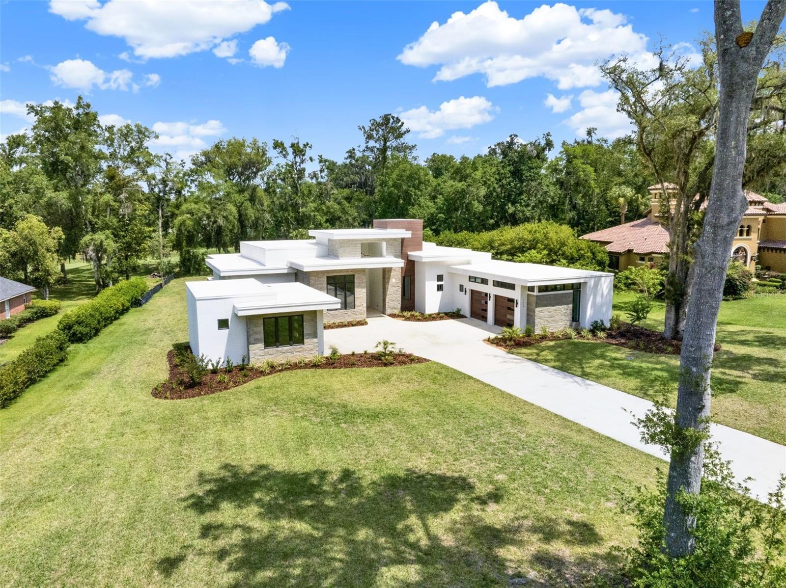 Experience the pinnacle of modern luxury in this extraordinary estate located within the unparalleled gated community of the Country Club of Ocala. Built in 2024 and never occupied, this architectural masterpiece offers the rare opportunity to own a near-new luxury residence in one of Ocala’s most coveted golf course communities.

Designed with both sophistication and comfort in mind, this contemporary five-bedroom, 4.5-bath home showcases sleek architectural lines, expansive living spaces, and high-end finishes throughout. A spacious club room provides the perfect setting for entertaining or unwinding in style, while a private home gym supports your wellness routine and a dedicated office offers an ideal space for remote work or quiet study.  Over $200,000 was spent on custom Ornare closets you had to see to believe.

The home is thoughtfully equipped with premium upgrades, including a whole-house Generac generator and advanced water treatment system, providing comfort and peace of mind year-round.

Beyond the home, residents enjoy the exceptional lifestyle offered by the Country Club of Ocala, featuring a championship 18-hole golf course, resort-style pool, tennis courts, and a state-of-the-art fitness center, all within a beautifully maintained gated setting.

This masterpiece is truly move-in ready... a remarkable residence representing a rare blend of modern design, luxury amenities, and tranquil Florida living.
