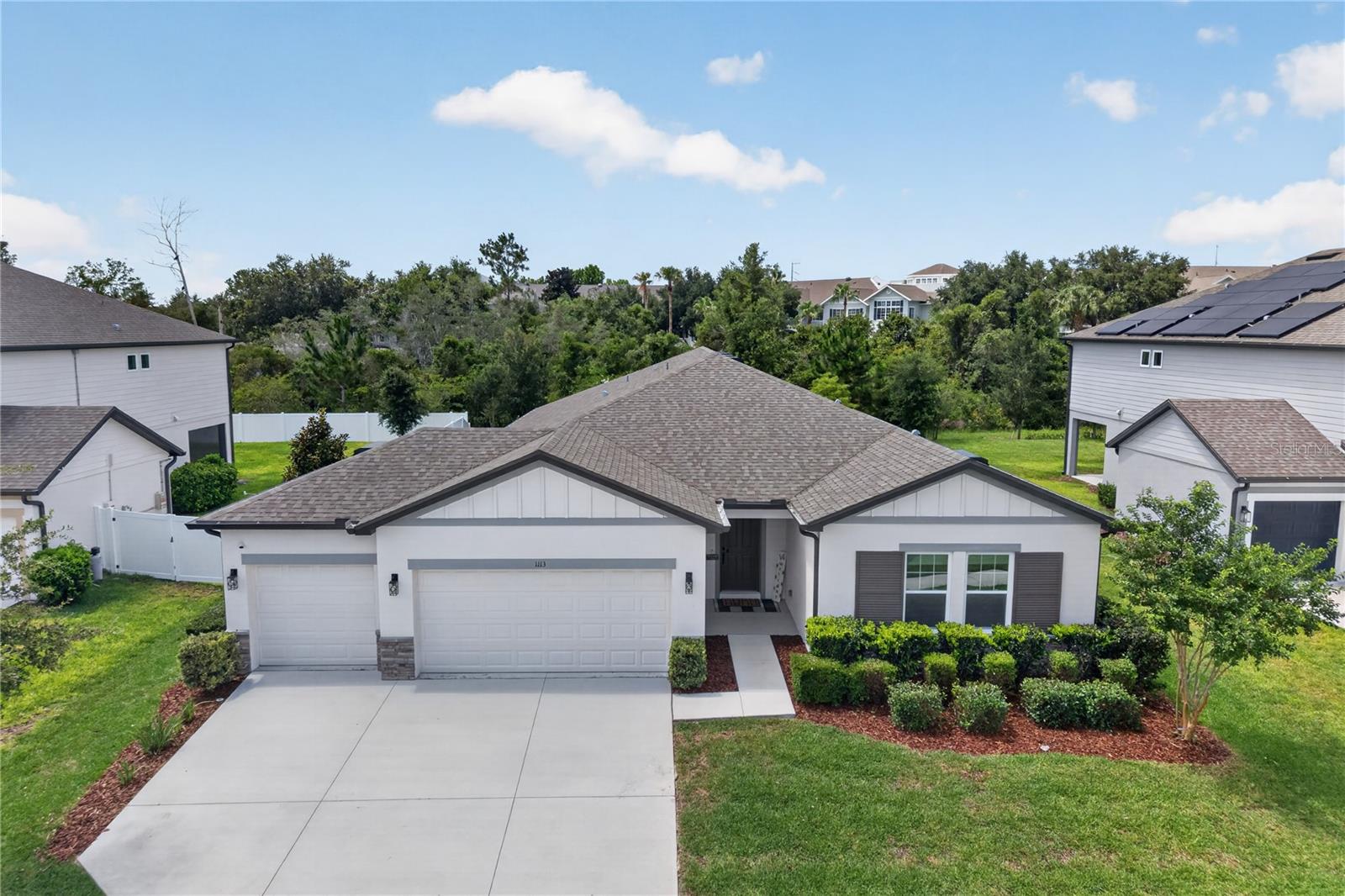 Welcome to this beautifully maintained 4-bedroom, 2.5-bath home with a 3-car garage in the desirable Hampton Oaks community of Deltona. Built in 2022, this spacious residence offers over 2,700 square feet of thoughtfully designed living space, combining modern style with everyday comfort.

Step inside to an open-concept floor plan featuring ceramic tile flooring throughout the main living areas for easy maintenance. The bright and inviting living room flows seamlessly into the well-appointed kitchen, complete with quartz countertops, stainless steel appliances, decorative backsplash, pendant and recessed lighting, abundant cabinetry, a large center island, and a spacious walk-in pantry. The generous dining area provides the perfect setting for everyday meals and entertaining.

A versatile flex room offers endless possibilities and can be used as a formal dining room, home office, den, playroom, or easily converted into a fifth bedroom. The split-bedroom layout provides privacy for everyone, while the spacious primary suite features a large walk-in closet and a luxurious en-suite bath with dual vanities and a walk-in shower with glass enclosure. Additional bedrooms offer plenty of space for family, guests, or multigenerational living. The home also includes a Nest Smart Thermostat for added comfort and energy efficiency.  Convenience continues with a dedicated indoor laundry room, complete with washer and dryer included, making move-in even easier.

Step outside through sliding glass doors to the covered lanai overlooking a fully fenced backyard with durable PVC fencing and a playground, creating the perfect space for outdoor entertaining, relaxation, and play.

Situated on a quarter-acre lot, this home offers plenty of room to enjoy the outdoors while remaining conveniently located near I-4, shopping, dining, medical facilities, parks, and major roadways, providing easy access to Orlando, Daytona Beach, and surrounding areas. Hampton Oaks features sidewalks, a community playground, low HOA fees, and no CDD.

Don't miss this opportunity to own a nearly new home that offers the perfect blend of space, style, and convenience. Schedule your private showing today!