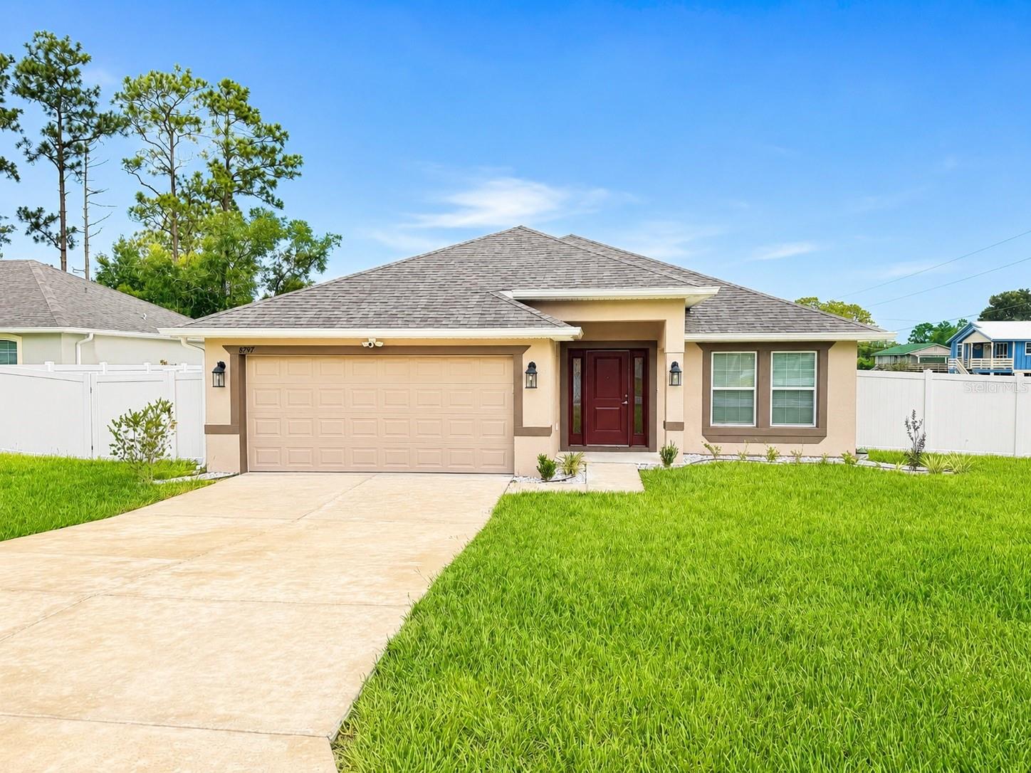 Be the first to call this BEAUTIFULLY BUILT, 4-bedroom, 3-bathroom home your own! Located in the highly sought-after Orange Blossom Hills community of Summerfield, this exceptional rental offers the perfect blend of modern living and an unbeatable location. Situated on a fully FENCED corner lot just across the street from The Villages and only minutes from The Villages Charter School, you'll enjoy quick access to shopping, dining, medical facilities, golf, entertainment, and everything The Villages has. Step inside to discover a bright, open-concept floor plan designed for both everyday living and entertaining. The spacious living room flows seamlessly into the oversized kitchen, featuring a large center island, abundant cabinet and countertop space, stainless steel appliances, and plenty of room to gather with family and friends. Ceramic tile extends throughout all of the main living areas, while the generously sized bedrooms provide comfortable retreats for everyone. One of the standout features of this home is that EVERY bedroom includes its own walk-in closet, offering exceptional storage rarely found in rental homes. The thoughtfully designed split floor plan also includes a private guest suite complete with its own en-suite bathroom, making it perfect for extended family, visitors, or anyone looking for additional privacy. The spacious primary suite offers a peaceful escape with a large walk-in closet, dual vanities, a walk-in shower, and a private water closet. Additional features include an indoor laundry room, whole-home water softener system, covered back lanai perfect for relaxing outdoors, and a fully fenced backyard providing both privacy and space to enjoy. With EVERYTHING BRAND NEW, energy-efficient construction, modern finishes throughout, and a location that simply can't be beat, this move-in-ready home is an incredible opportunity to enjoy luxury, convenience, and low-maintenance living in one of Summerfield's most desirable communities. Don't miss your opportunity to lease this exceptional home!
