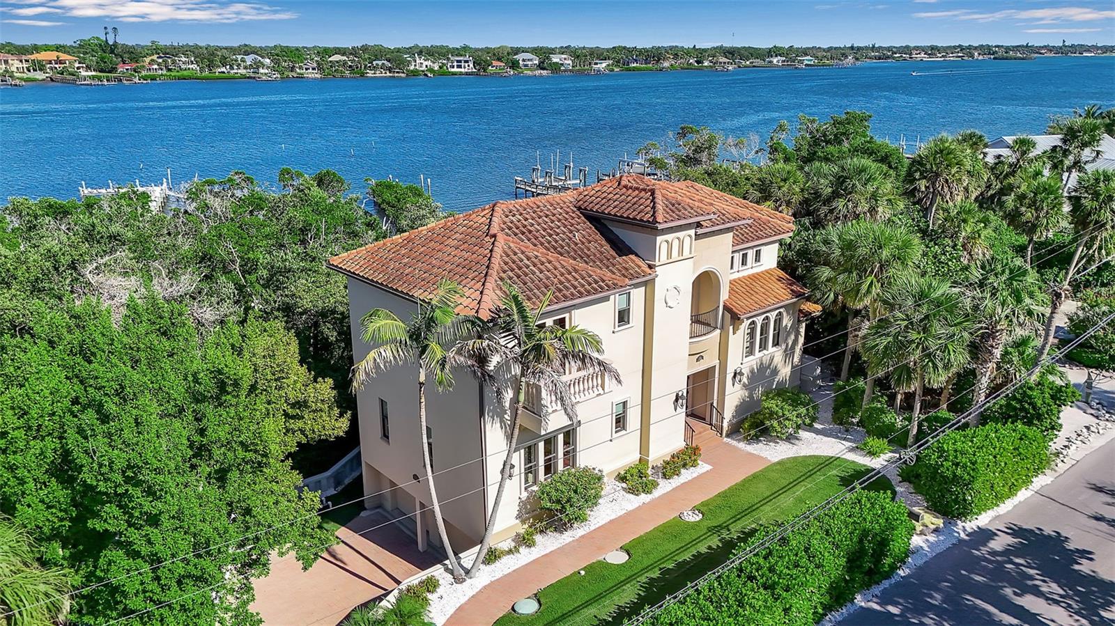 Beautiful Custom Built Waterfront Home on Casey Key. This waterfront residence on exclusive Casey Key, offering the ultimate in coastal luxury with deeded Gulf beach access and a deep-water dock on the Intracoastal Waterway. Designed for effortless indoor-outdoor living, this open-concept home features a spacious great room with decorative fireplace and a gourmet kitchen with Viking Professional Series appliances, walk-in pantry, and large center island.

Walls of glass open to expansive outdoor living spaces with a summer kitchen, balcony, and sparkling pool, creating a seamless setting for entertaining and relaxation. All four bedrooms feature private en-suite baths with TOTO and Kohler fixtures and designer finishes in natural stone, porcelain, glass, and metal. The oversized primary suite is a private retreat with generous proportions and luxurious detail.

Exceptional quality throughout includes hurricane-rated windows and doors, granite and marble countertops, 8-foot solid-core doors, crown molding, elegant millwork, oversized garage, elevator-ready design, and whole-house generator. Custom built to Florida Green Building Standards for energy efficiency and environmental sensitivity. 

Enjoy one of Casey Key’s most coveted lifestyles.  Ideally located near downtown Sarasota’s acclaimed dining and cultural offerings, as well as the charming shops and waterfront restaurants of Venice. Convenient to three major airports and the private airport in Venice.