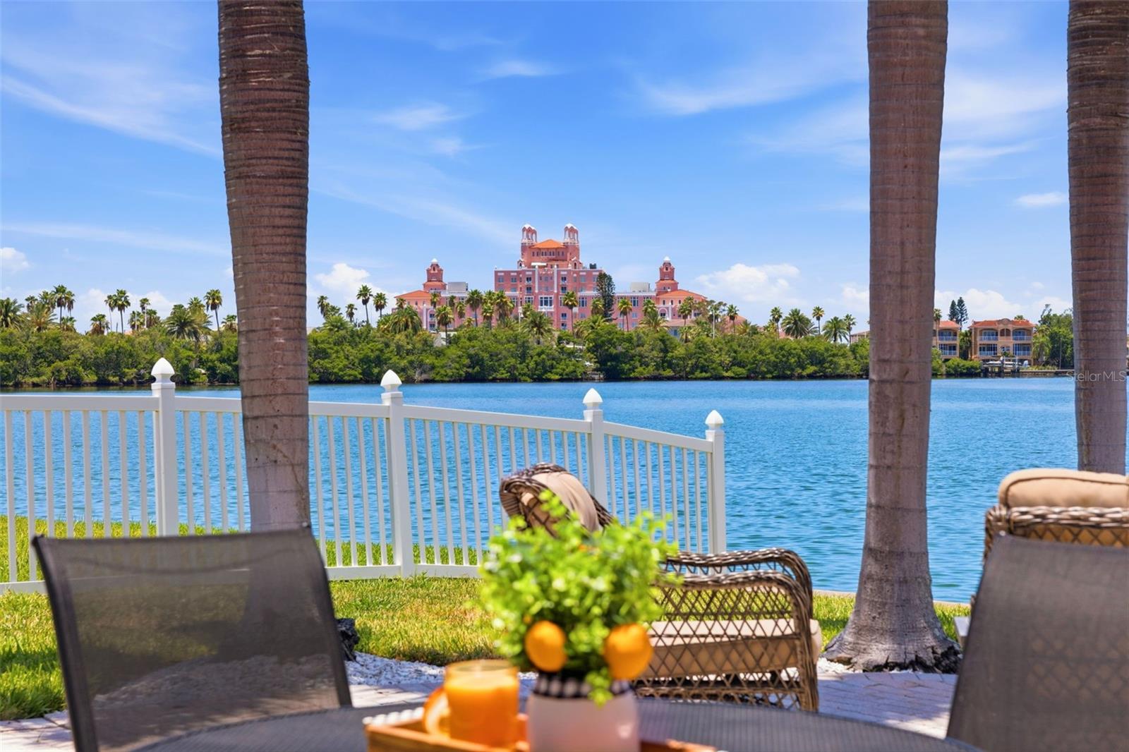 PRIME BELLE VISTA LOCATION - ST PETE BEACH WATERFRONT HOME AND BOATERS' PARADISE! Awaken each morning to serene waterfront views and end your day with spectacular sunsets overlooking the iconic Don CeSar. pink hotel.  Some locals even call this "THE TROPHY VIEW".  You will understand once you catch your first sunset from the glorious waterfront patio in the back of this coastal luxury property.  Nestled in the sought-after Belle Vista neighborhood of St. Pete Beach, this beautifully maintained 3-bedroom, 2-bath waterfront home offers the perfect blend of coastal charm, privacy, and island living. Move-in ready with 2025 kitchen updates including a large island, electrical improvements, and newer water heater, this home is situated on a quiet lot surrounded by mature tropical landscaping. The expansive waterfront patio is ideal for entertaining or relaxing beneath the motorized retractable awning, while the private dock with a new lift motor provides easy access for boating, kayaking, paddle boarding, fishing, and enjoying the abundant marine life. Inside, terrazzo and tile flooring throughout create a clean, low-maintenance coastal aesthetic. The spacious waterfront great room with vaulted ceiling is the star of the show in this coastal home, capturing breathtaking views through the beckoning wall of windows.  The primary suite features an en-suite bath, while the generously sized guest bedrooms provide comfort and flexibility. The third bedroom opens directly to the patio, creating seamless indoor-outdoor living and is a continuation of the natural light that graces the entire home. The two car garage with excess storage in addition to the separate storage room, is also the location for the washer and dryer.  There is a newer garage door opener with remote to make access convenient and efficient. Find private beach access just across Gulf Boulevard and enjoy the sugar-white sands of world-renowned St. Pete Beach.  Just minutes from dining, shopping, and entertainment, this property is an exceptional opportunity as a primary residence, vacation retreat, or investment.
