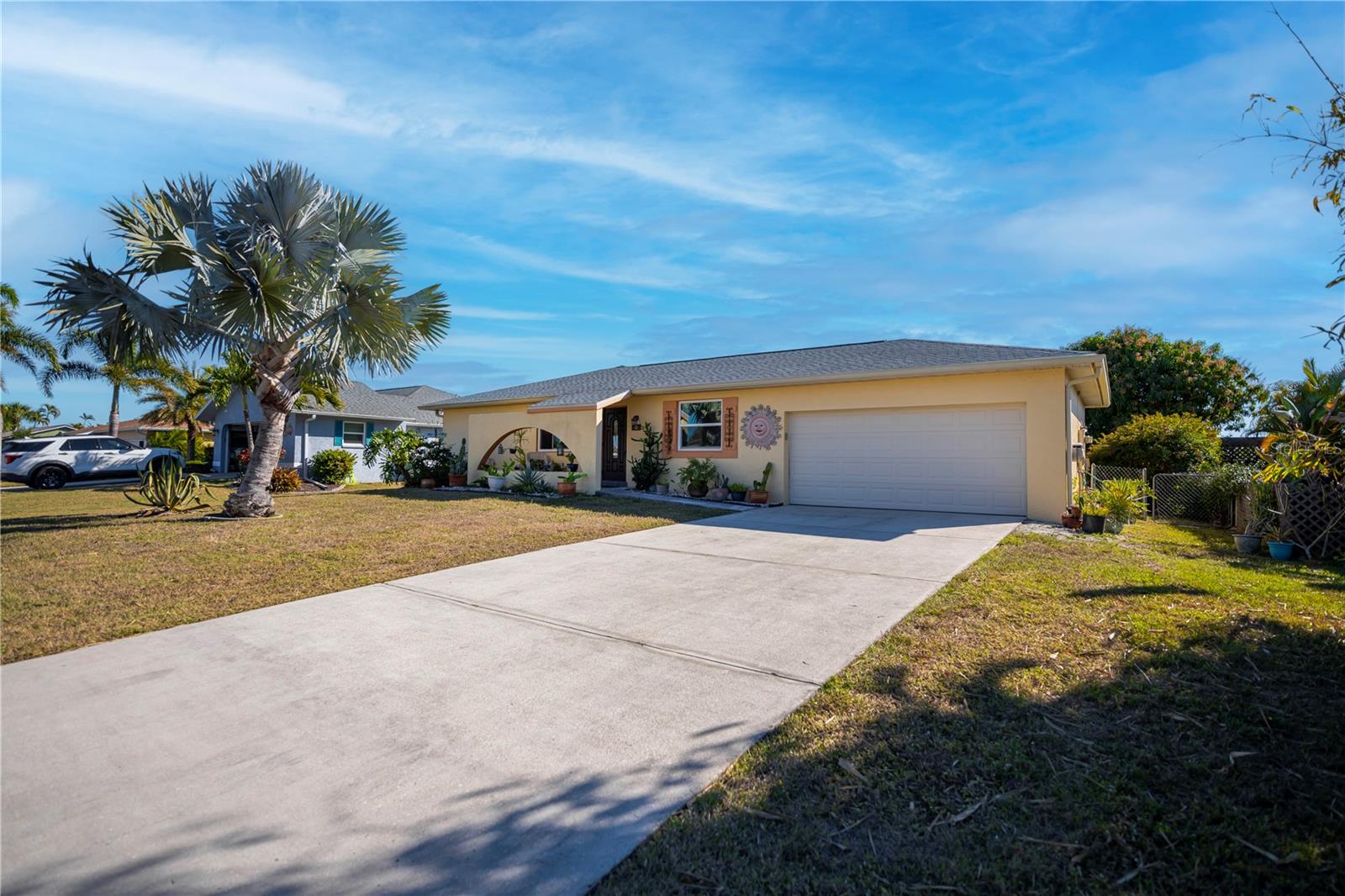 From the moment you arrive at 242 Annapolis Lane, you’ll feel the soothing natural ambiance that makes Rotonda West so special. Sunshine dances across the façade, welcoming you home, while the peaceful freshwater canal in your backyard quietly calls to the angler in you. Cast a line, sip your morning coffee, or simply watch the water shimmer—this is Florida living at its finest. Step outside to your private oasis, where two majestic mango trees provide shade and seasonal treats. The stamped concrete patio is the perfect place to unwind, entertain, or soak up the coastal breeze. With a fully fenced backyard, your fur babies and little ones can roam freely while you relax knowing they’re safe. Inside, nearly 1,400 square feet of thoughtfully designed living space unfolds. The split-bedroom floor plan offers privacy, with both bedrooms featuring their own en-suite bathrooms. You’ll love the no-carpet design, easy-care flooring, and the bonus den/office/craft room—perfect for hobbies, remote work, or quiet retreats. The kitchen is conveniently located near the laundry room and garage, making grocery days a breeze, and a charming nook beneath the window invites you to create a cozy bistro corner or workspace overlooking the backyard. This home has been lovingly maintained with major updates already done for you: a new roof in 2023, A/C in 2022, new windows in 2021, full repiping in 2013, and a brand-new hot water heater in 2025. Sitting high at 10.2 feet above sea level, the homeowner reports no flooding during recent hurricanes—offering priceless peace of mind. Can be purchased *TURNKEY FURNISHED* for $5,000 (with a few exclusions) outside of the contract! On city water and sewer, and includes a two-car garage. Rotonda West’s low annual HOA of just $190 keeps community standards high without breaking the bank. Need space for your toys? There’s community storage available for boats or RVs. Golfers will love having five public golf courses right in the neighborhood, and beach lovers will appreciate being just 20 minutes from Manasota Key and Boca Grande’s pristine shores. This is more than a home—it’s a lifestyle. Schedule your showing today and start living the Florida dream you’ve been waiting for!