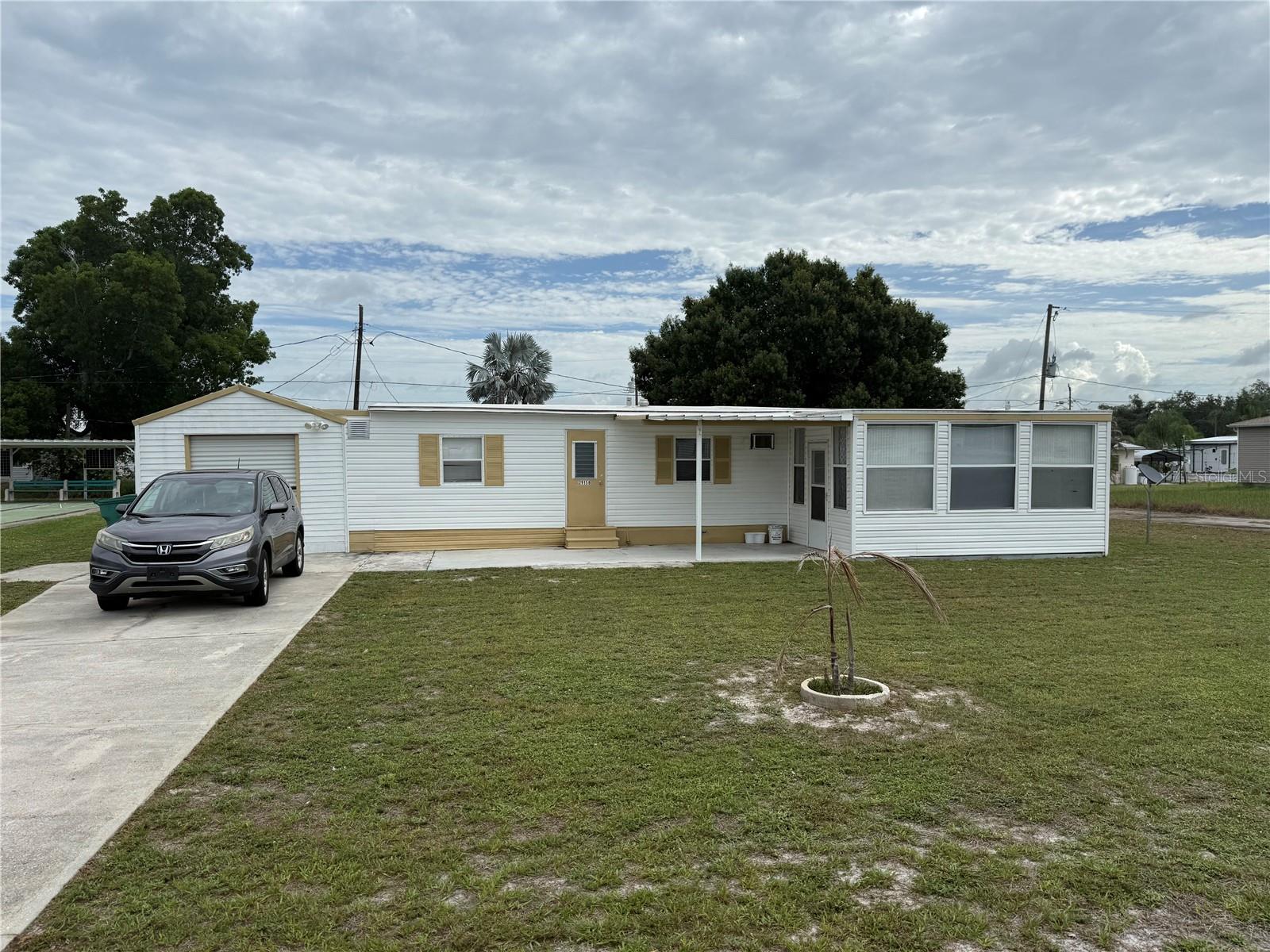 Own your land and enjoy the freedom of no HOA at this well-maintained 3-bedroom, 2-bath home in Punta Gorda. Built in 1965 and offering approximately 1,100 square feet of living space, this property features ceramic tile flooring throughout and a flexible bonus room that is perfect for a home office, hobby room, or additional living space.

The open floor plan connects the living room, Florida room dining area, and kitchen, creating a comfortable flow for everyday living. The primary bedroom features a walk-in closet and convenient access to the oversized shed. The indoor laundry room includes the washer and dryer, making move-in easy.

Recent updates provide added peace of mind, including a 2017 roof with transferable warranty, updated electrical panel, newer well pump, newer water heater, and newer wall-unit air conditioners. The oversized shed has electricity and offers excellent storage or workshop space.

Outside, you'll find an enclosed front patio, a long driveway with ample parking, and a backyard orange tree that adds a touch of Old Florida charm. Located in Flood Zone X, flood insurance is not typically required by lenders.

Conveniently situated near US-17 and I-75, this property offers easy access to downtown Punta Gorda, Port Charlotte, Arcadia, shopping, dining, medical facilities, and Punta Gorda Airport. Whether you're looking for a full-time residence, seasonal retreat, or investment opportunity, this property offers affordability, flexibility, and the added benefit of land ownership.