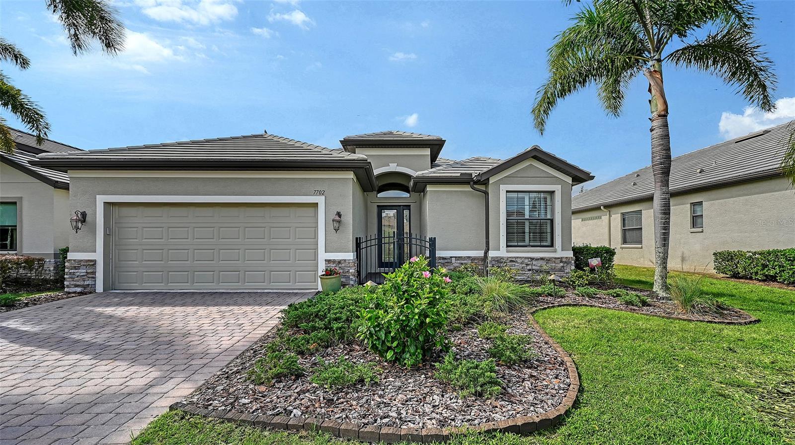 Virtually Staged. Motivated Seller! Discover exceptional value in one of Sarasota’s most desirable locations. This meticulously maintained, maintenance-free home in the gated community of Riva Trace offers the perfect blend of quality, convenience, and lifestyle—all with low HOA fees and no CDD. Built in 2013, this thoughtfully designed three-bedroom, two-bath residence showcases upscale finishes throughout. Inside, you’ll find diagonal tile flooring spanning the entirety of the home, soaring 10–12 foot ceilings, 8-foot doors, and an open, airy layout filled with natural light. The kitchen is both stylish and functional, featuring granite countertops, stainless steel appliances including a new refrigerator, gas cooking, glass tile backsplash, under-cabinet lighting, and solid wood cabinetry with pull-outs. Enjoy a newly remodeled walk-in shower in the primary bathroom. Additional upgrades include plantation shutters, hurricane protection, double-pane windows, built-in closet systems, designer lighting, and a whole-home air purification system. Step outside to an extended lanai overlooking a peaceful, private backyard with extra side-yard space—perfect for relaxing, entertaining, or gardening. A Sunsetter canopy and fenced area add flexibility for pets or outdoor enjoyment. Located just west of I-75 along the highly sought-after University Parkway corridor, this home places you minutes from everything. Enjoy close proximity to The Mall at University Town Center, featuring over 150 shops and restaurants, as well as easy access to downtown Sarasota, parks, and the area’s renowned Gulf Coast beaches. Residents of this intimate community of just 86 homes enjoy tile roofs, paver driveways, and a beautifully maintained setting. A rare highlight is private water access—offering a community park with a fishing and observation deck, canoe launch, and storage. Combining low-maintenance living with upscale features and an unbeatable location, this home is an outstanding opportunity—ideal for downsizing, seasonal living, or simply enjoying the best of Sarasota.