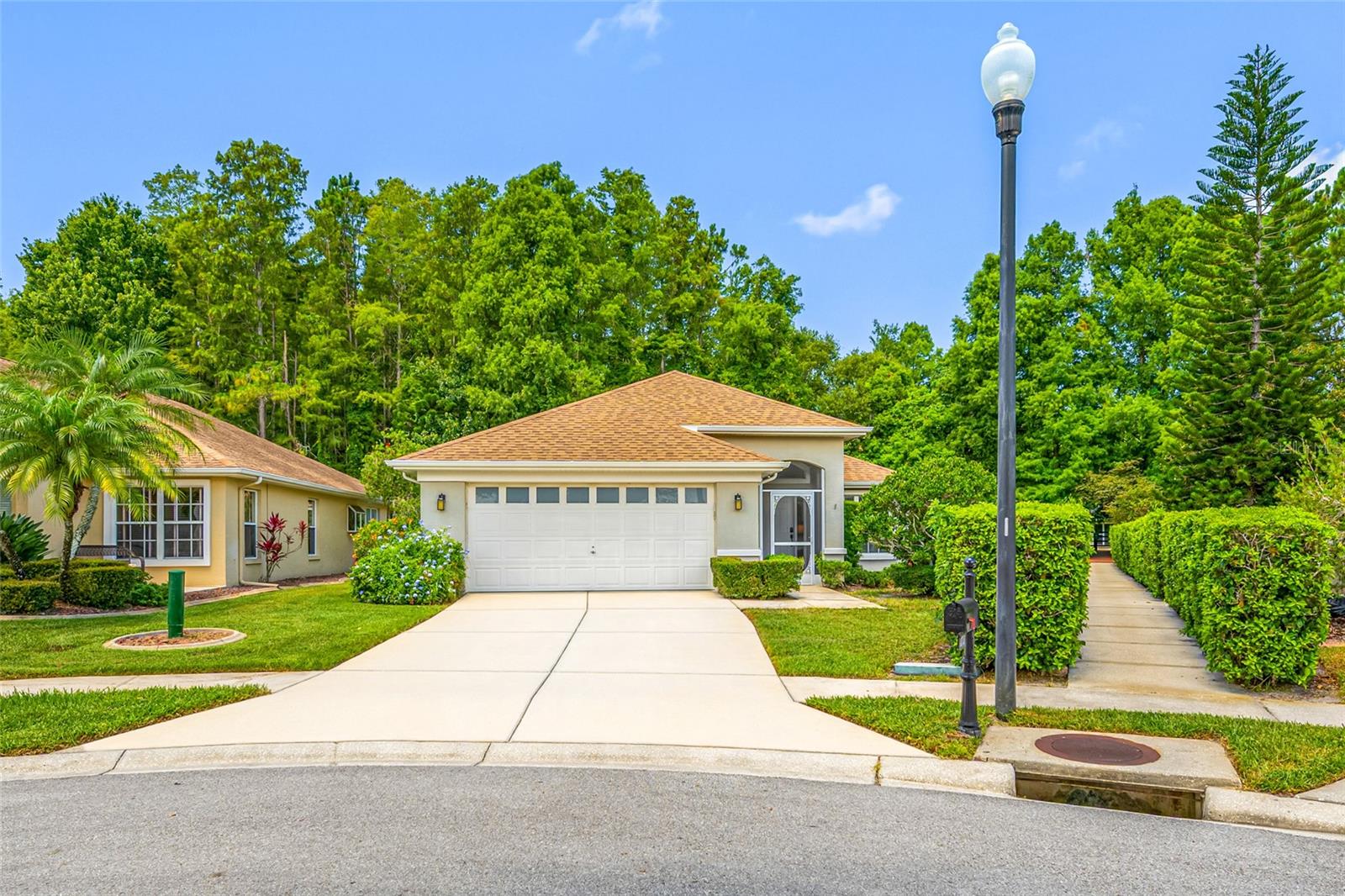Stunning home in Trinity! This open and bright 3-bedroom, 2-bathroom, 2-car garage home is located in the highly sought-after gated community of Wyndgate. Situated on a generous lot, the property features a large side yard that borders the walkway leading directly to the community pool. As you arrive, you'll be welcomed by a private screened front porch before entering the formal living and dining areas. The kitchen offers an abundance of cabinet space, granite countertops, stainless steel appliances, a breakfast bar, and a pantry. It overlooks the spacious family room and provides beautiful views of the backyard and conservation area beyond. The primary suite is generously sized and features private access to the large backyard patio. The en-suite bathroom includes dual vanities, a walk-in shower, and a private water closet. The guest bedrooms are conveniently located adjacent to the guest bathroom. Designed for entertaining, this home offers both indoor and outdoor covered living spaces. Major updates include a new roof in 2022 and A/C system is 2023. Wyndgate is a small, maintenance-free community with a low HOA fee that includes grounds maintenance, a community pool and spa, trash service, hedge trimming, and sprinkler system maintenance. Located within an A-rated school district, this home is conveniently close to restaurants, shopping, top-rated Gulf beaches, and much more. Enjoy easy access to both Pinellas and Hillsborough counties, making commuting and recreation a breeze.