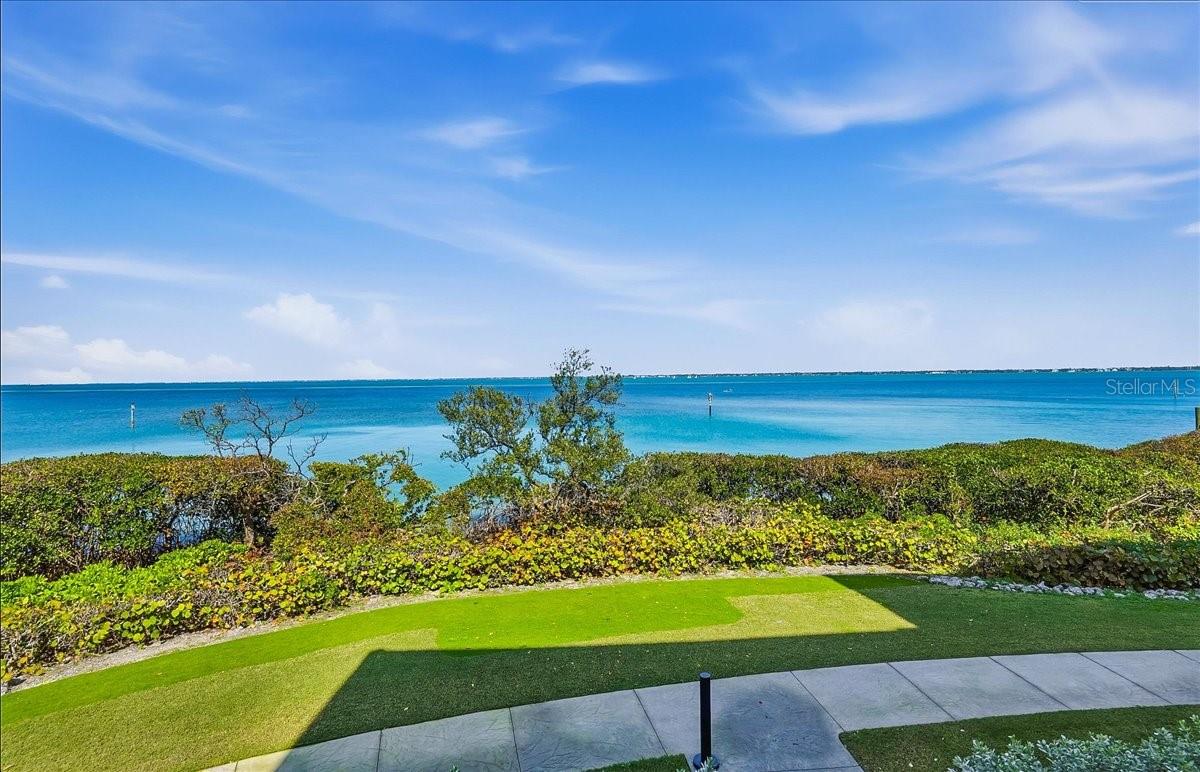Virtually Staged. 2BD+DEN! Positioned as the southern-most community on Longboat Keys’ Gulf of Mexico Drive is the stunning Tangerine Bay.  Its presence of pristinely manicured tropical color admired by all that enter the Key.  Within this gated community lies #515- horizontal to Sarasota’s bayfront experiencing views that span across blue waters abundant with active sea-life.  This 2bd/Den/2.5bath/2-car private garage home, with excellent wall space for displaying your finest art collection, extends over 2,300 square feet of living space.  Courtyard entry, equipped with gas hook-up for your own grill, offers slider access into the kitchen/ family room area which is perfect for a different entertaining perspective since the courtyard is large enough to also accommodate table and chairs.  Of course, the coveted place to dwell will be the grand living/ dining area and balcony to experience morning sun over the calming waters or the miracle of all the hues the sky can offer as the sun begins to set behind you.  Large primary en-suite enjoys the water view and slider access to the balcony, considerably sized walk-in closet and super-spacious bathroom to create the spa-like atmosphere of your dreams.  #515 will not disappoint with the generous kitchen, kitchen water filtration, split floorplan, updated windows and doors, 2024 remote roll-down hurricane shutters, 2023 A/C, 2026 water heater, roof and sprinkler heads replaced approx. three years ago.  With a spanning lap pool, meandering lush lounging areas, spa, fishing/day dock, tennis/ pickleball, fitness center and clubhouse- Tangerine Bay is poised for pleasure to all who get to call it home.  For a small annual fee, owners can also become members of the Bay Isles Beach Club.