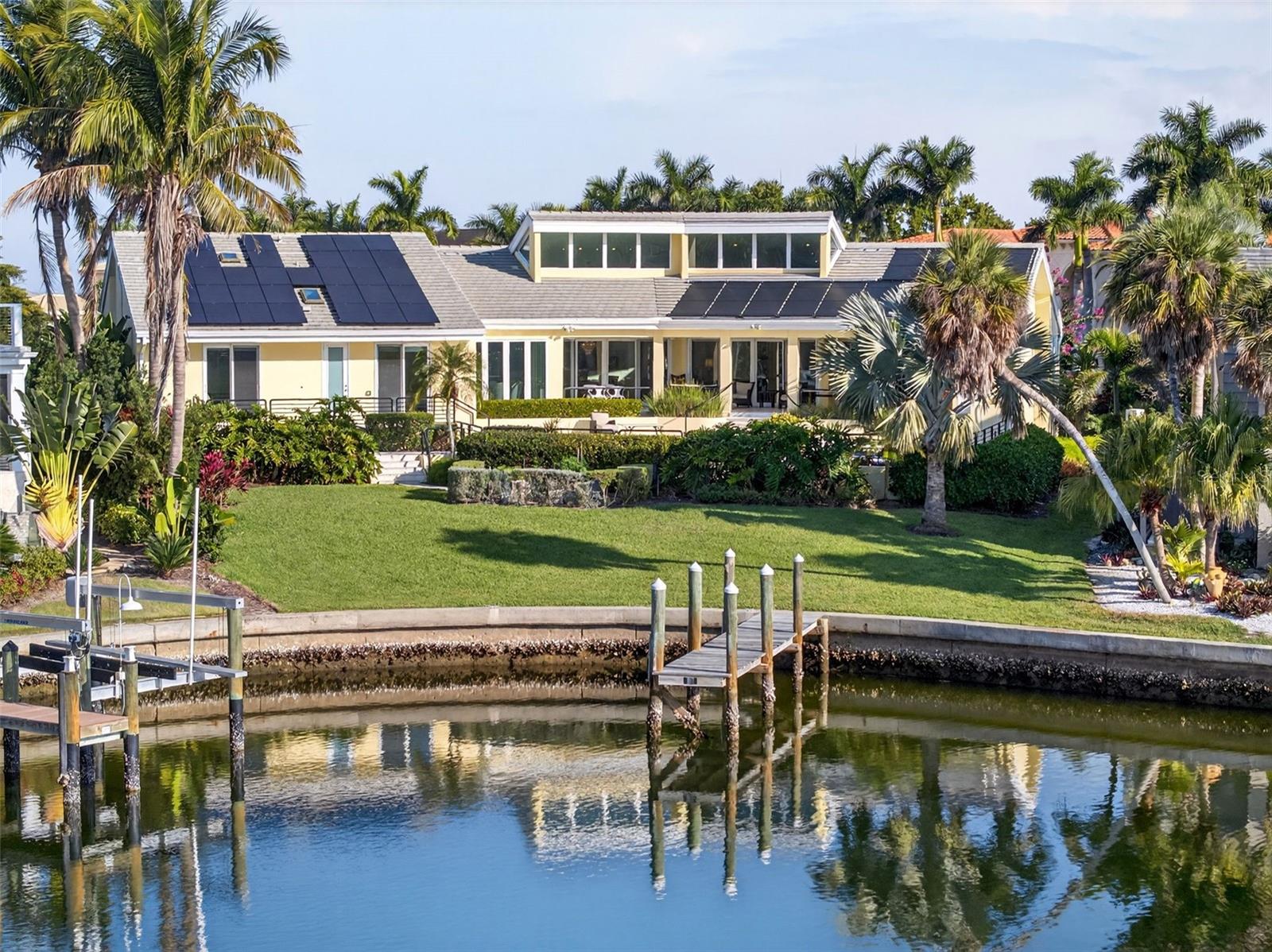 Experience the ultimate in luxury coastal living in this 4,209-square-foot stunning waterfront home, perfectly situated in the highly sought-after, gated Bay Isles Harbor Section—an exclusive boating community with only 67 custom residences on south Longboat Key.
Designed for elegance and comfort, this timeless 4-bedroom, 3.5-bath estate welcomes you with a dramatic open main living area featuring soaring 23-foot ceilings filled with natural light, rich oak flooring, custom lighting and a gas/wood-burning fireplace. Expansive walls provide the perfect showcase for fine artwork, while the spacious living and dining areas flow seamlessly into a warm family room and a chef’s dream kitchen.
The gourmet kitchen is equipped with custom mahogany cabinetry, premium stainless-steel appliances including an induction cooktop, a large island topped with quartzite countertops, and a bright breakfast area overlooking the pool and waterway.
Sliding glass doors lead to your private outdoor oasis—a massive 28-foot saltwater pool with solar heating and a partially covered patio with heat-resistant coral stone tile.
The luxurious master suite offers two walk-in closets, a sitting area or office, and a spa-inspired bathroom with translucent onyx walls and flooring, a soaking tub, and an oversized shower. Additional features include a large laundry and craft room, an oversized two-car garage with workbench, hurricane-impact windows and doors, reinforced garage doors, and a brand-new concrete tile roof.
A beautifully landscaped circular drive welcomes guests, while the deep-water bayou behind the home provides direct access to Sarasota Bay—ideal for boating enthusiasts.
Residents of Bay Isles enjoy 24-hour gated security, membership to the Bay Isles Beach Club, and close proximity to the Longboat Key Club, St. Armands Circle, world-class dining, shopping, and the brand-new five -star St. Regis Longboat Key Resort.
This exceptional property offers the best of luxury, privacy, and the coveted waterfront lifestyle on Florida’s Gulf Coast.