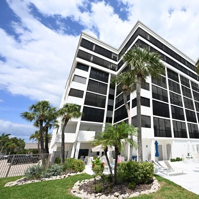 Welcome to southern coastal living at Lido Surf & Sand. Showcasing full panoramic Gulf views and daily sunsets, this direct beach-front 5th floor condo features a 2-bedroom, 2-bathroom, boasting 1,494 sq. ft. of interior living space and an additional 394 sq. ft. expansive wraparound balcony. Wake up to coffee or tea on your private balcony with limitless beach views and end your day listening to the gentle surf a mere 200 feet from your residence. The open-concept layout presents a seamless flow from dining area through living room to the full-width beachfront balcony?perfect for intimate evenings or entertaining friends. After a refreshing swim in the beachside pool, relax in the heated spa, lounge with a good book on the pool deck, or play a game of shuffleboard with friends. A fitness center, billiards, nearly renovated social room, and garage make this a great place to live. Your pet is also welcome! Upgrades include a new water heater (2023), brand new A/C unit, and upgraded hurricane-impact windows and sliders. A short stroll down the block, the Ted Sterling Nature Preserve beckons the outdoor enthusiast - from early morning walks to gentle kayaking in the mangrove maze. Exceptional shopping and dining await at nearby St. Armands Circle. Come and check out this unit for yourself today!