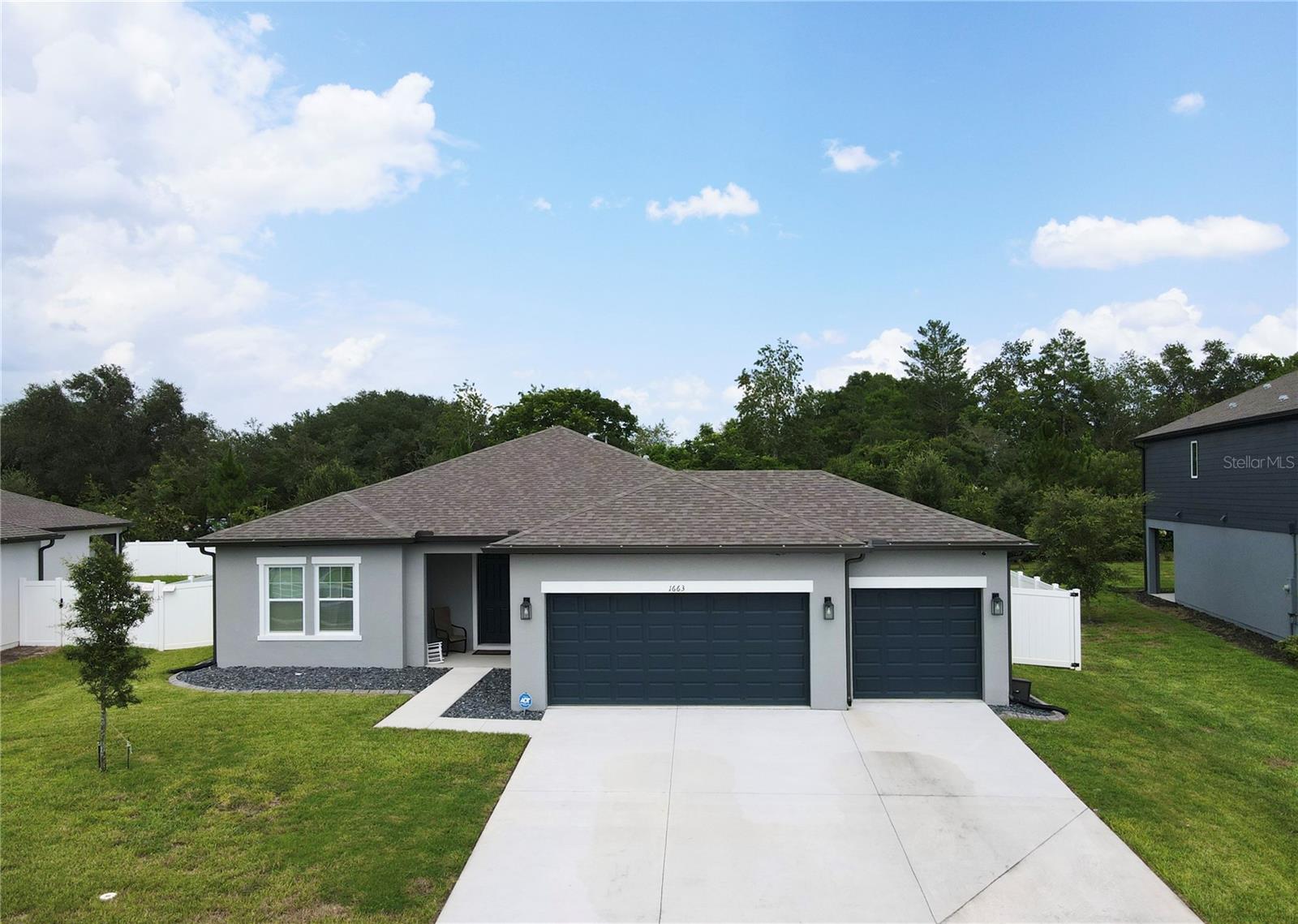 Welcome to this beautifully maintained 2024-built home offering 4 spacious bedrooms, 3 full bathrooms, and a desirable 3-car garage. This move-in ready home has been thoughtfully cared for and features numerous upgrades throughout. The fully fenced backyard provides plenty of space to relax and entertain, with a covered porch. A dedicated play area featuring soft rubber mulch-perfect for the little ones. The home is also pre-wired for a security system and the Sellers are leaving their security systems behind. Wanting a future pool in the backyard? The home already comes pre-wired for a pool, making it easy for the next owner to customize the outdoor space. Sellers has also installed permanent lights to the exterior of the home, so any holidays, sporting games, or celebrations, you can light up this home! Inside, you'll find a modern, open layout with ALL APPLIANCES INCLUDED, allowing for a seamless move-in experience. Conveniently located near Publix, Walmart, Walgreens, other retail stores and restaurants. Along with easy access to I-4, this home also offers a quick drive to New Smyrna Beach and Daytona Beach, providing the perfect balance of everyday convenience and Florida's lifestyle! Don't miss this opportunity to own a like-new home that's been meticulously maintained and is ready for its next owner! Schedule your private showing today!