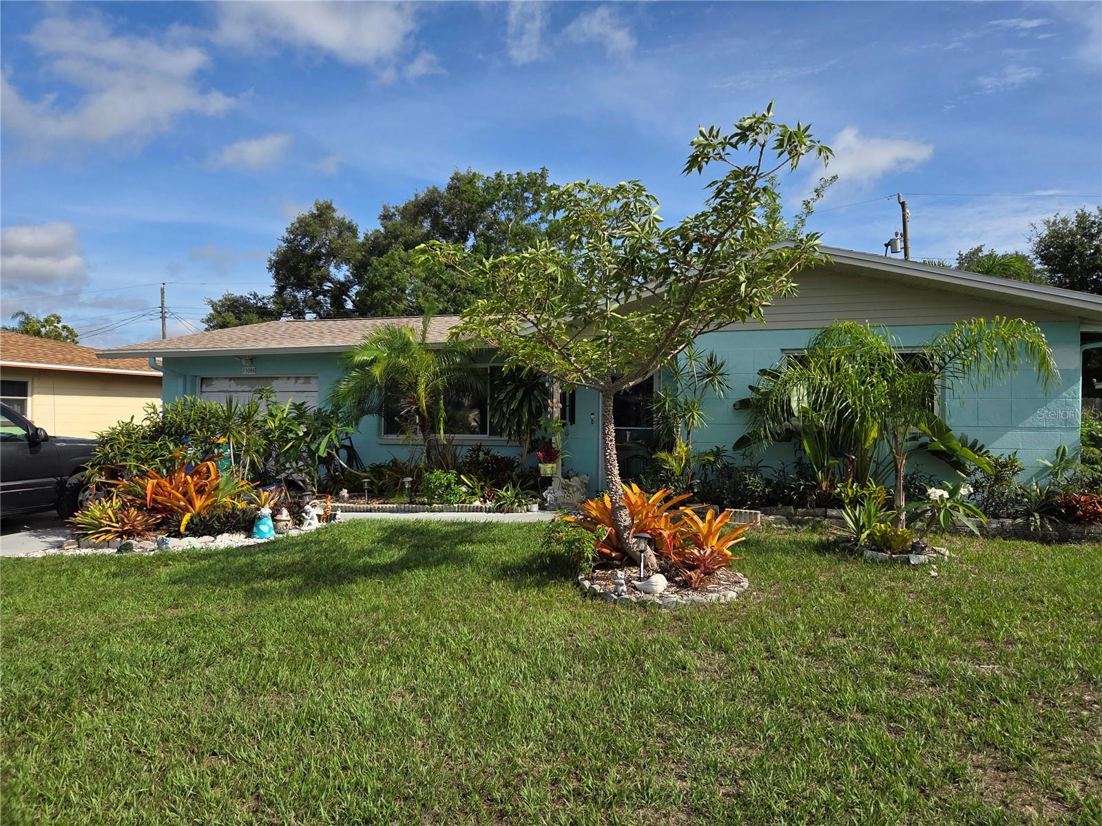 Live in a home with character. Your plant lover’s dream. Solid block home with a new roof in 2025 and a newer AC. Porcelain tile in living room, dining room and kitchen. Tiled Florida room off the dining room, great for an office or even an extra bedroom. Back screened in patio great for enjoying our Florida evenings with a glass of wine. Put your grill on the slabbed side yard and enjoy a good steak. Let’s talk about the back yard. Escape to your own private island, lush with landscaping that needs some TLC to bring it back to life. This sweet home is located in Seminole, minutes to Seminole Lake and Park and 10 minutes to the beaches.
