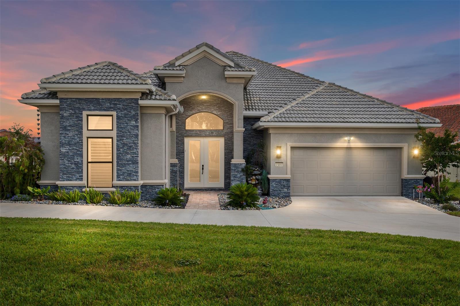 In the gated lifestyle community of Terra Vista, this custom-built 2024 Wentworth residence in the exclusive Halls Reserve enclave offers 3,162 square feet of thoughtfully designed living space on a desirable corner homesite. The three-bedroom, three-full-bath and one-half-bath home blends architectural detail, accessibility and resort-style outdoor living, with every bedroom designed as a private en suite featuring zero-clearance showers and grab bars for comfort and convenience. Architectural details include elevated tray ceilings in the foyer, rotunda, family room and primary suite, solid-core interior doors, plantation shutters, transom windows and upgraded tile flooring throughout the main living areas and primary suite. The gourmet kitchen is appointed with custom white maple cabinetry, Cambria countertops, under-cabinet lighting, a gas cooktop, double ovens, a second dishwasher, microwave drawer, icemaker and wine cooler. A dedicated office features built-in cabinetry and counters, while the primary suite offers a freestanding soaker tub, vessel sinks, upgraded granite countertops and custom cabinetry. Designed for indoor-outdoor entertaining, the lanai showcases a custom Gunite saltwater pool with heat and waterfall feature, outdoor shower, outdoor kitchen, dry bar, custom gas fire pit, electric awnings, mural screen and a dedicated surround sound system. Additional features include a whole-house generator, monitored security system, Ring cameras and doorbell, 400-amp electrical service, whole-house gutters with rain barrels and upgraded lighting with dimmers throughout. The grassy area adjacent to the garage is included with the property, and the sellers have received architectural committee approval for a future casita or additional one- to two-car garage. Residents enjoy access to Terra Vista’s amenity-rich lifestyle near boating, fishing, hiking and biking destinations throughout Citrus County. Mandatory social membership required with refundable $2,000 deposit due at closing. Near the new 589 extension, you’ll enjoy easy access throughout the region with a one-hour ride to Tampa International Airport.