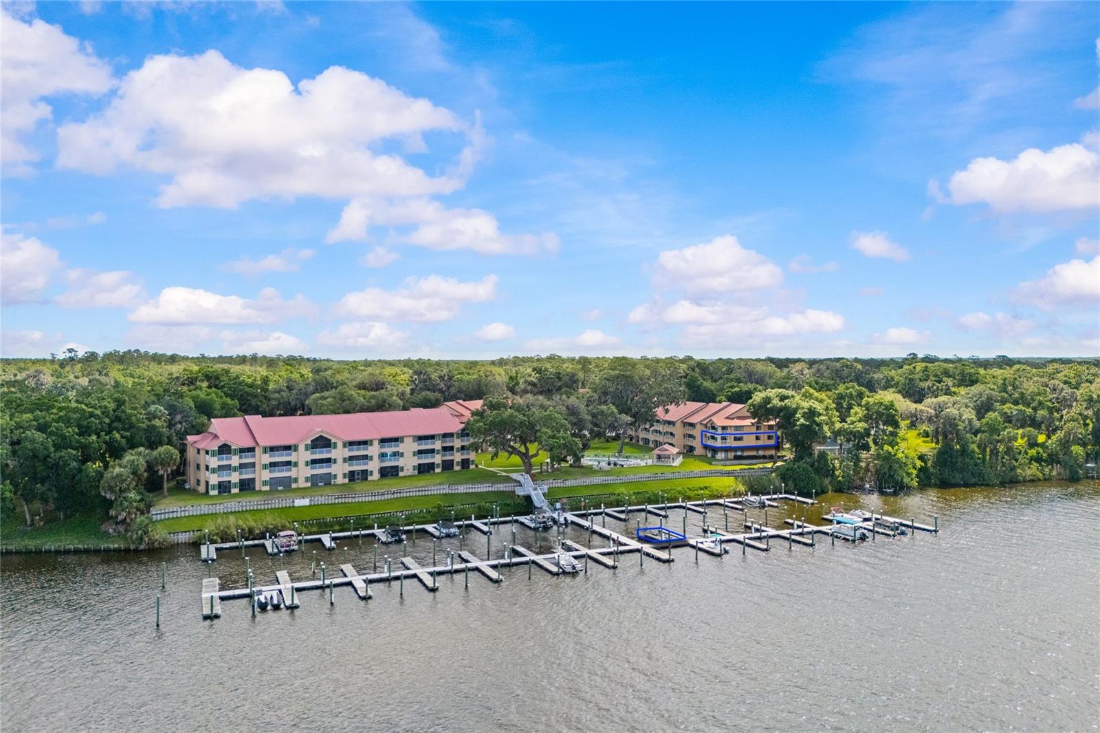 Location! Location! Location! Discover true waterfront living with this exceptional riverfront condo in the heart of charming Welaka, Florida! Featuring 3 bedrooms, 2 bathrooms, elevator access, and a deeded boat slip with jet ski-ready access, this beautifully positioned second-floor unit offers the perfect blend of lifestyle, comfort, and investment potential. With approximately 1,568 square feet of living space, this highly desirable condo is filled with natural light thanks to its abundance of windows and breathtaking panoramic river views. Enjoy spectacular sunsets overlooking the St. Johns River from your living room, dining area, kitchen, primary suite, second bedroom, and private balcony. The gourmet kitchen is equipped with real wood cabinetry, granite countertops, and ample space for cooking and entertaining, seamlessly flowing into the open living and dining areas designed to maximize the incredible waterfront scenery.
A spacious laundry room with washer and dryer included adds extra convenience and functionality. Whether you enjoy boating, fishing, skiing, or simply relaxing by the water, this property places you in the center of it all. Located in Flood Zone X, this elevated condo offers added peace of mind and has remained safe from flooding. The community amenities are designed for relaxation and enjoying the riverfront lifestyle. Two swings, a fire pit, and gas grills round out an amenity package built for unwinding -- not upkeep. Even better -- short-term rentals are allowed with a 1-week minimum, making this an incredible opportunity for a vacation home, full-time residence, or income-producing investment property. This is truly one of the most desirable units in the complex, offering unmatched views, abundant natural light, elevator convenience, and an unbeatable price for riverfront living.
Schedule your private showing today -- this must-see waterfront gem will not last long!