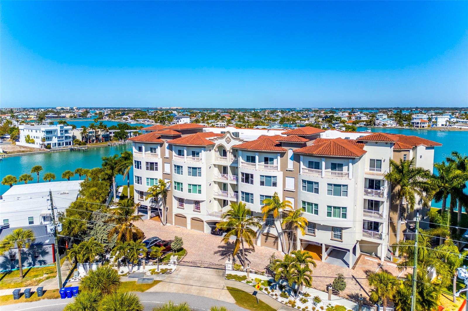 Experience the ultimate in Florida island living at La Bella Vita, an exclusive gated waterfront community of only 16 residences, ideally located on the bay and just one block from desirable Treasure Island Beach. This newer, secured building features a private lobby entrance and high-speed semi-private elevator.

Complete Coastal Package-this rare expansive end condo residence offers over 3,100 square feet with 4 bedrooms, 3.5 baths, a private 2-car garage-equipped with 48 AMP EV charging station, and deep water boat slip with easy Gulf access.

The artful, open, light-filled floor plan showcases 10’ ceilings, tray ceilings, crown molding, designer lighting. You will enjoy the expansive kitchen with granite countertops, wood cabinetry with pull-out shelving, glass tile backsplashes, and stainless steel appliances. The luxurious primary suite features direct balcony access, stunning water views, an oversized walk-in closet, and a spa-inspired bath with garden Jacuzzi tub, oversized tiled shower with dual heads and seating. A second bedroom also enjoys access to a private balcony. Enjoy sweeping bay views from the private oversized balconies, and every room, enhanced by the highly desirable end-unit location.


Resort-style amenities include a heated waterfront pool and spa, paver sun deck, dock, and a deeded boat slip — perfect for boating enthusiasts to explore our vibrant coastal community.
Perfectly positioned between the sugar sands of the Gulf and the vibrant energy of Downtown St. Pete, you truly get the best of both worlds. Walk out your front door or cruise from your backyard dock to enjoy waterfront dining, live music, boating, fishing, and endless beachside fun. When you’re ready for a more cosmopolitan vibe, Downtown St. Petersburg is just 15 minutes away, offering world-class museums, galleries, shopping, fine dining, craft cocktails, festivals, and nightlife. From sunsets on the beach to evenings on Central Ave, this is Florida living at its finest.