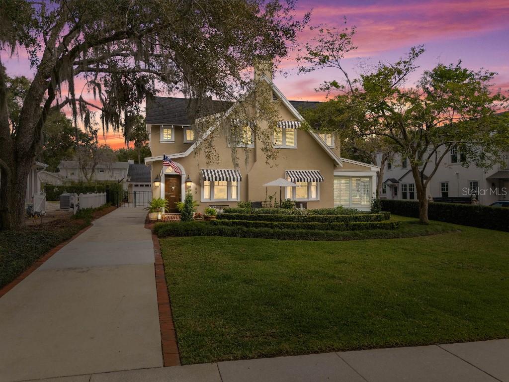 Welcome to this beautifully renovated century home on one of the most picturesque brick streets in Olde Winter Park. Take a leisurely stroll down to Lake Mizell or enjoy the views from its large front patio. This classic pool home is filled with charm, natural light and is designed for easy entertaining. The spacious layout offers multiple rooms for every occasion, including a bright sunroom, cozy living room with a fireplace, and a large welcoming family room. The gourmet kitchen features custom wood cabinets, quartzite counters, a convenient office nook and an adjoining breakfast room, while the formal dining room boasts elegant moldings and built-in corner cabinets. A secret basement presents options for additional storage or a wine cellar. 
The second floor features a generously- sized master suite, two additional bedrooms, two updated baths, and a versatile nursery or bonus room, perfect for a study or home office. The property includes a detached two-car garage and a charming guest house with a bedroom, bath, and loft area. 
Newly renovated resort back yard includes heated salt water pool and spa, multiple seating areas, complete with gas hookups for fire pit and outdoor kitchen and a maintenance-free travertine and turf pool scape. You’ll love the inviting ambiance of both this home and its vibrant Winter Park location.