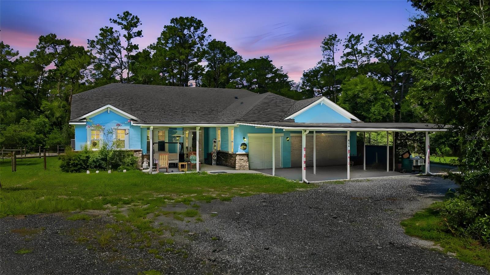 LAKE HELEN: WHOLE HOUSE GENERATOR | 5 YEAR OLD ROOF, AC & HOT WATER HEATER | RV HOOK UP: Escape to your own private retreat in the heart of Florida's charming countryside! Nestled on 3.13 acres of beautifully secluded land, this spacious 4-bedroom, 3-bathroom home offers the perfect blend of comfort, functionality, and outdoor living.

A welcoming front porch sets the tone as you arrive, while the expansive property features a finished RV port, shed, dedicated dog run, and plenty of room to enjoy the peaceful surroundings. The Massive carport is a great asset when raining-you can walk from the carport into the home without getting wet! The oversized screened porch is designed for entertaining, complete with a fully equipped outdoor kitchen where you can relax and enjoy the tranquil views year-round.

Inside, the inviting living room showcases a decorative fireplace framed by stunning floor-to-ceiling brick accents and multiple colored settings to set the mood for any event. There are also triple sliding glass doors that seamlessly connect indoor and outdoor living spaces. The spacious eat-in kitchen is sure to impress with stainless steel appliances, a gas stove, decorative backsplash, large center island with bar stool seating, and an oversized walk-in pantry offering abundant storage-it has room for 3 refrigerators!

The private primary suite serves as a relaxing retreat with tray ceilings, a ceiling fan, French doors leading to the screened porch, and a luxurious En-suite bathroom featuring double sinks, a garden tub, walk-in shower, and beautiful custom wood cabinetry. The additional bedrooms are generously sized, providing plenty of space for family and guests. A dedicated office offers the perfect work-from-home setup, while the inside laundry room includes a utility sink and extra shelving for folding and organization. The whole house generator adds comfort during Hurricane Season to ensure you will not loose power. 

Located in one of Florida's most treasured small towns, known as the "Gem of Florida," you'll enjoy a lifestyle rich in history and charm. Famous for its preserved 19th-century character, tree-lined streets, scenic equestrian trails, and the rare distinction of having no traffic lights, this unique community offers a peaceful pace of life while remaining convenient to modern amenities.

If you've been searching for privacy, acreage, and a home designed for both everyday living and entertaining, this exceptional property is a must-see!