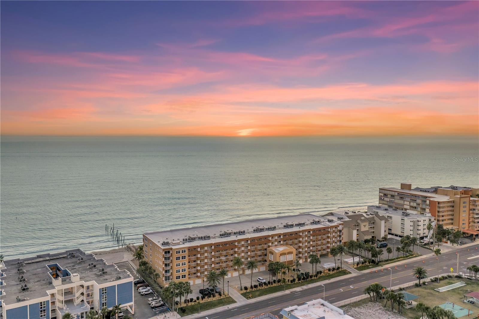 Where the sky melts into the Gulf each evening and salt air drifts through open doors, life at La Contessa in Redington Beach feels beautifully unhurried. Setting this exceptional residence apart at the very beginning is the private one-car garage (in addition to an assigned parking space) - a true rarity for beachfront condos. Take a secured elevator to a semi-private landing on the 4th floor (only shared with one other unit) and walk through the double doors to your new slice of paradise. At the heart of the home, a massive kitchen anchors the living space with abundant cabinet storage and counterspace. The open concept dining and living areas are spacious and illuminated by the sunlight pouring in through the sliding glass doors (or turn down the natural light with the brand new motorized sun shades over the sliders). The primary suite is positioned beachside so that even from bed you have a clear uninterrupted view of the water, and opens to the balcony through another set of sliders, also featuring new motorized shades. Completing the primary suite are dual closets and an oversized primary bathroom featuring a large soaking tub, a separate walk-in shower, a water closet, linen closet, and dual sinks with abundant storage. The other designated bedroom has a walk-in closet and en-suite bathroom, while a spacious bonus room is ideal for a third bedroom, home office, or private den (or the perfect combination of all three), plus a hall bath for all guests' convenience. But outside is where the nature show really takes off. The beach-facing private balcony becomes your front-row seat to golden sunsets, green flashes, dolphin shows, and midsummer afternoon storms rolling in from offshore. Through the den is a door to yet another balcony along the east side of the building, which could be the perfect spot to enjoy a cup of coffee with a sunrise view. La Contessa also boasts a newly renovated resort-style outdoor space, featuring TWO Pebbletec pools, an oversized spa, a fabulous grill station, poolside bathrooms, brand new outdoor furniture, and new pavers to lead you down to our famous Redington Beach — elevating the amenity experience well beyond the ordinary. Less than an hour drive to THREE major airports, less than 3 miles to John's Pass, and walking distance to several local dining favorites... this location is one you really would never want to leave.