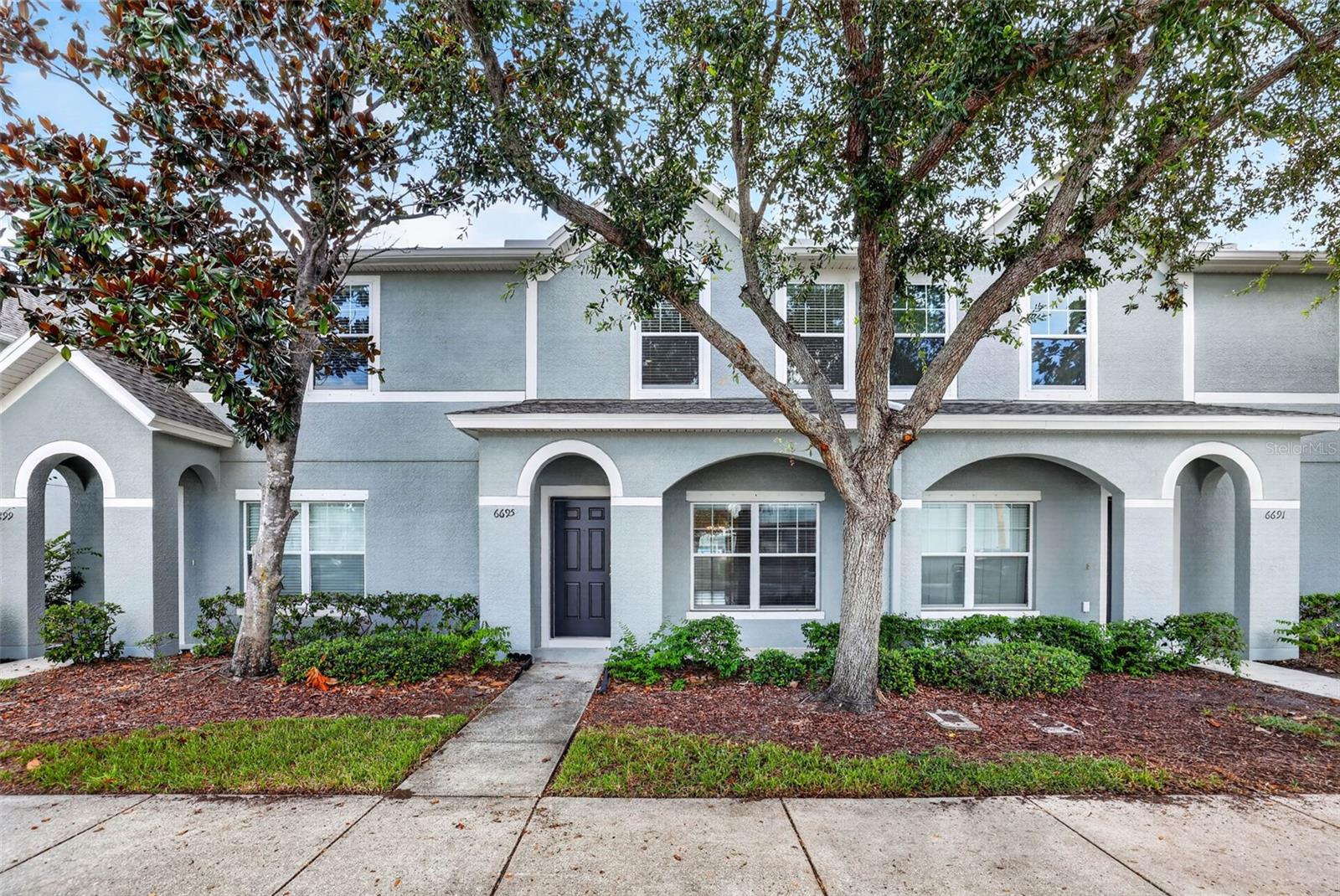 Virtually Staged. Welcome to Sawgrass Village, where low-maintenance living meets comfort and convenience. This move-in ready 2-bedroom, 2.5-bath townhome offers a well-designed floor plan in a desirable community featuring a pool, dog park, sidewalks, and ample guest parking.

Inside, you'll find fresh interior paint, abundant storage, and a functional layout. The kitchen features a breakfast bar for casual dining and opens to a designated dining area, creating an ideal space for entertaining and gathering with family and friends. Sliding glass doors lead to a private rear patio, providing the perfect spot for grilling, outdoor dining, or relaxing with your morning coffee.

Upstairs, both bedrooms feature their own private en-suite bathrooms, creating an ideal setup for roommates, guests, families, or those working from home. The spacious primary suite includes a walk-in closet and an oversized garden soaking tub. The laundry area is conveniently located between the bedrooms, eliminating the hassle of carrying laundry up and down stairs. A first-floor half bath adds additional convenience for guests.

Residents enjoy a low HOA, one assigned parking space, ample guest parking, community pool, and dog park. The location places you minutes from shopping, dining, movie theaters, parks, world-famous Gulf beaches, and an easy drive to Downtown Tampa, Tampa International Airport, and major commuter routes.

Home includes hurricane shutters. Major updates have already been completed, making this home truly move-in ready. Roof 2025, AC 2022, Water Heater 2021.