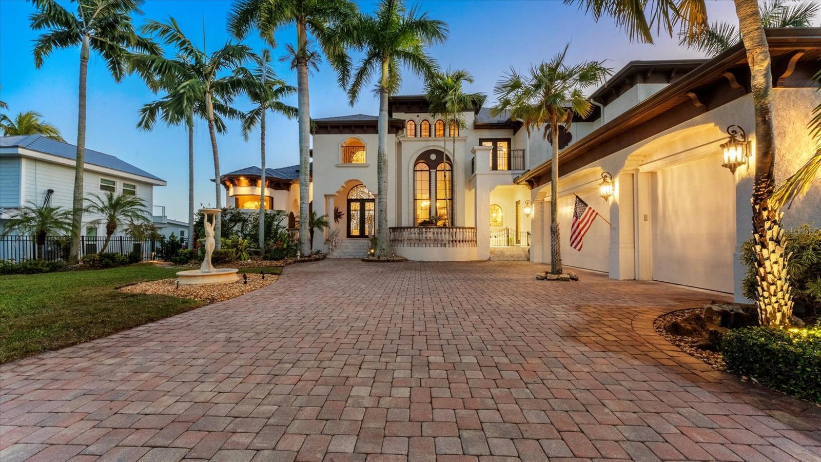 Discover the ultimate in luxury living in this exquisite John Cannon home, Southwest Florida's most celebrated, award-winning custom home builder for over three decades. This phenomenal residence exudes timeless sophistication and refined coastal living. Set on 98 ft of frontage along the tranquil shores of Dona Bay, this amazing home boasts over 5,700 square feet of thoughtfully designed open-concept living space enhanced by soaring 30-foot ceilings, three fireplaces, a sweeping staircase, polished travertine floors throughout and beautiful Mediterranean architectural interests. Formal and casual living areas unfold seamlessly, opening to multiple balconies, ideal for entertaining and relaxed waterfront living. The magnificent kitchen serves as heart of the home, featuring exotic 2-inch blue Bahia granite counters, a large gas range, three dishwashers, three copper sinks, and wet bar with walk-in 1,000-bottle wine cellar. The main floor also boasts two grand living areas with stunning water views, one of two primary suites, two guest bedrooms, 2 1/2 baths and a butler pantry with laundry facilities. The elevator leads to the second floor, where a dedicated game room, private office and magnificent primary suite serve as a private sanctuary, opening to a romantic terrace overlooking the bay. A closet fit for royalty also hosts a washer and dryer for convenience. The primary bath boasts a full room mirror, two large vanities, walk in shower and Roman tub. Outdoors, the home’s graceful lines lead to an infinity saltwater pool with a sun deck, spa, full bath with air conditioner and resort-style entertainment area, all shaded by 92 palm trees. A bayfront walkway leads to the new Trex dock with a 10,000-pound lift, completing the experience. This is a four-zone house, all units new, a new steel EDCO roof and two septic tanks with new floats and pumps. There is also a central vacuum system for cleaning ease. The extensive list of improvements is available in the attachments. Be sure to watch the video and walk-through floor plan.