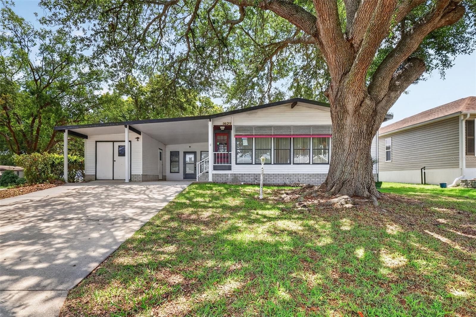 Enjoy the Florida lifestyle in this spacious 2 bedroom, 2 bathroom manufactured home located in The Villages adult golfing community in Lady Lake. Nestled on a shady lot in the desirable Village of Orange Blossom Gardens, this home offers an open-concept layout with a spacious kitchen featuring ample cabinetry and eating space, a formal dining room, large family room, and a bright Florida room perfect for relaxing or entertaining. The generous primary suite includes a walk-in closet and a large private bath, while the indoor laundry room adds convenience. Outside, you'll find a detached workshop with plenty of space for hobbies, storage, or projects. Residents of The Villages enjoy an abundance of amenities including golf courses, pools, recreation centers, dining, shopping, entertainment, and endless activities in one of Central Florida’s most sought-after active adult communities. No Bond!!!!All information recorded in the MLS is intended to be accurate but cannot be guaranteed, buyer advised to verify. Sold As-Is