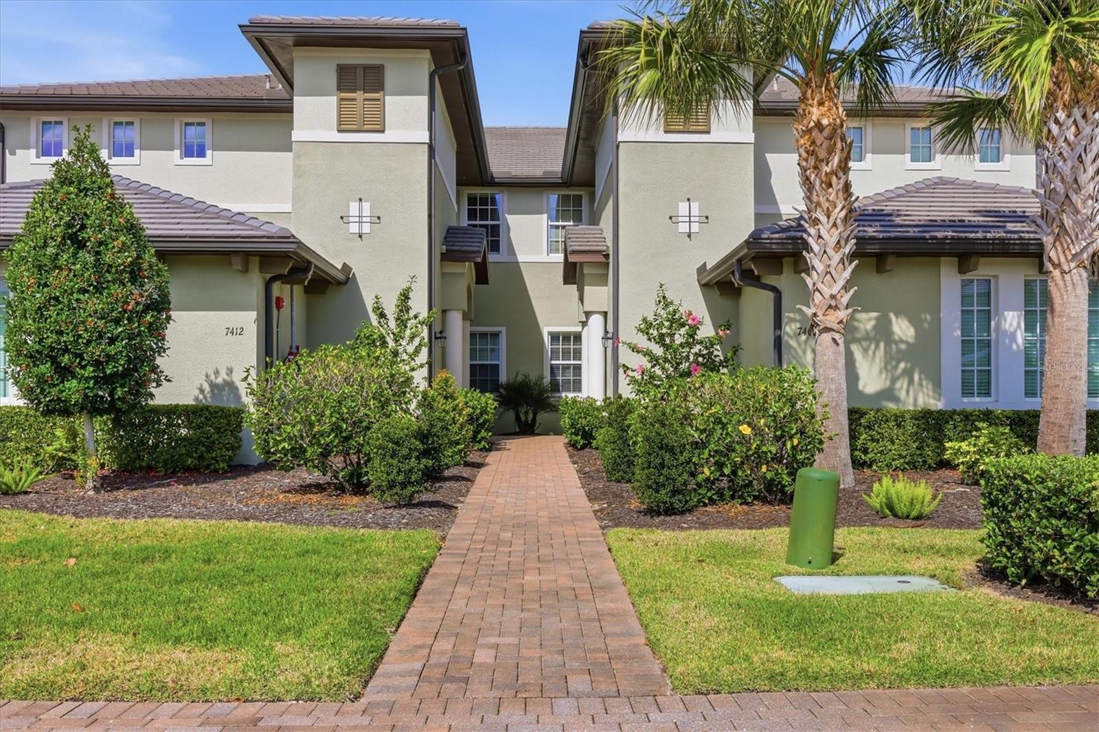 Fantastic, Immaculately Clean, Meticulously Maintained 2nd Floor 3 Bedroom, Den, 2 Bath SPACIOUS coach home Clubside in Country Club East of Lakewood Ranch. SPECTACULAR LONG RANGE GOLF COURSE VIEW! THIS VIEW IS A WOW! Gated, and Private Guard House Entrances into your upscale and well kept community. Beautifully decorated Great Room living space with engineered hardwood floors and crown molding. Tall Ceilings, Hunter Douglas Blinds and Plantation Shutters enhance the decor. Hurricane Impact Triple and Double sliders with access to the extra wide lanai with extra comfy seating to enjoy the amazing backdrop. Light and Bright! Open concept Kitchen with 42" tall white cabinetry and white quartz countertops, stainless steel appliances and a gas range. Huge One level Island to gather round when entertaining! Dining area can accommodate a large table and additional eating area for a smaller table. Primary Bedroom suite with same golf course view, Crown Molding, Coffered ceilings, ensuite Bath with dual sinks, quartz counters, large linen closet, walk in closet, and a frameless shower enclosure. Guest Bedrooms split plan in the front of the unit with a full guest bathroom in between. Comfy Den/Study across from Guest bedrooms. Plenty of closet space and oversized attached two car garage. Never run out of hot water with a Tankless Gas Water Heater. All Windows and Doors are Hurricane Impact rated. The Retreat is an amazing upscale Clubhouse for residents and their guests only. Gorgeous Pool, Fitness Center, and Patio Situated on The Royal Lakes Golf Course offering beautiful Golf Course and Lake vistas. The Lodge and several Golf courses Require an additional Country Club Membership. Lakewood Ranch is an award-winning master-planned community with glorious weather, top-rated schools, and a perfect inland location. Enjoy proximity to world-renowned beaches (Siesta Key, Lido, Longboat, and Anna Maria), public golf courses, boating, fishing, biking, walking trails, UTC Mall, and countless restaurants. Downtown Sarasota and Bradenton offer vibrant dining, rooftop bars, arts, and cultural venues. Multiple international airports within an hour. Welcome to the Gulf Coast lifestyle!