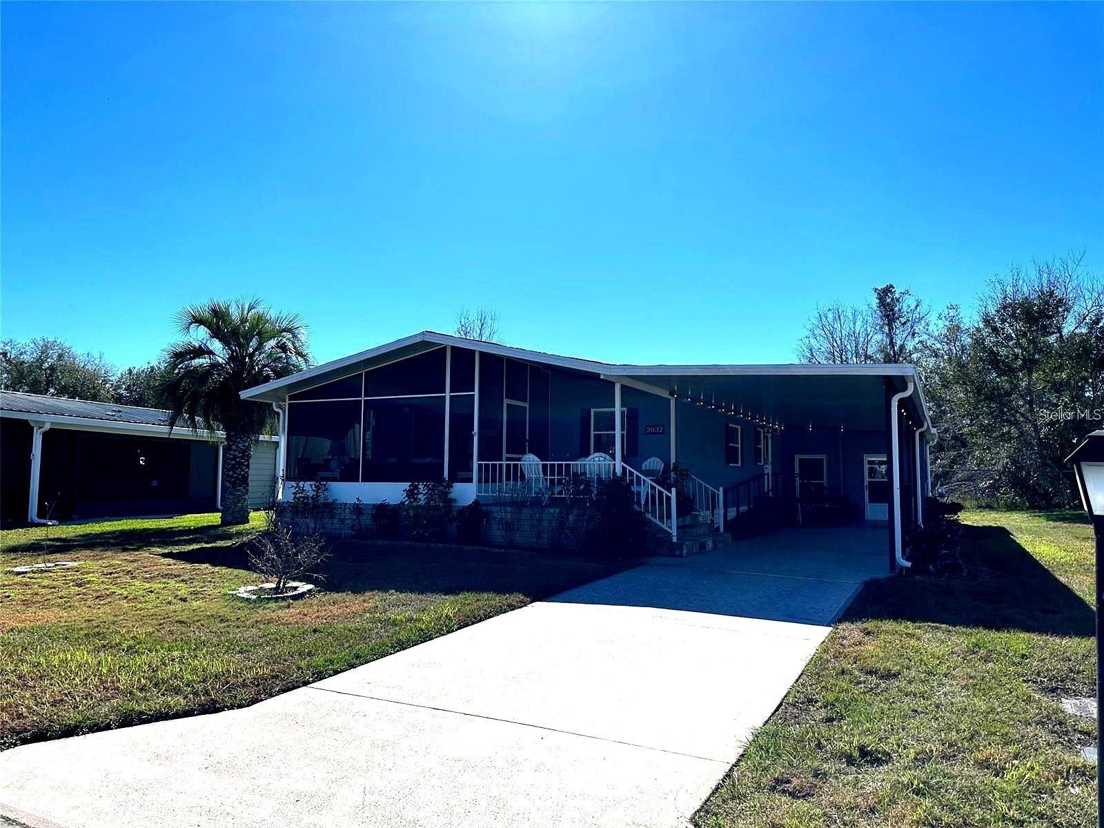 Price to SALE, this charming 2-bedroom, 2-bath home offers comfort, functionality, and the Florida lifestyle you’ve been dreaming of—now priced aggressively for a quick sale!

Featuring laminate flooring with a durable plywood subfloor throughout, high ceilings in the main living areas, and a spacious interior laundry room, this home is designed for both style and convenience.

Enjoy a bright and open living space highlighted by a stunning stone wood-burning fireplace. The kitchen is light-filled and inviting, featuring a large farmhouse-style sink and updated appliances—perfect for everyday living and entertaining.

The oversized primary suite offers a relaxing retreat with dual sinks, updated faucets, a stylish barn-style sliding door, and a therapeutic walk-in tub. Both bedrooms include cedar-lined walk-in closets, providing ample storage. The guest bathroom has also been fully updated with a new shower, sink, and fixtures.

Step outside to your expansive outdoor living areas, ideal for enjoying Florida’s beautiful weather. This property features an oversized screened and covered front porch, as well as a separate stone-covered patio with privacy blinds—perfect for relaxing or entertaining while enjoying unobstructed views.

Additional highlights include:
• Updated plumbing
• Fresh interior and exterior paint
• 48’ covered carport 
• Two exterior storage units plus added storage throughout the home
• Pet-friendly community

Located in a desirable 55+ resident-owned, gated golf course community with association approval required. The seller is open to including furniture (excluding personal items), offering a true turnkey opportunity.

Measurements and timelines are approximate and should be independently verified by the buyer.