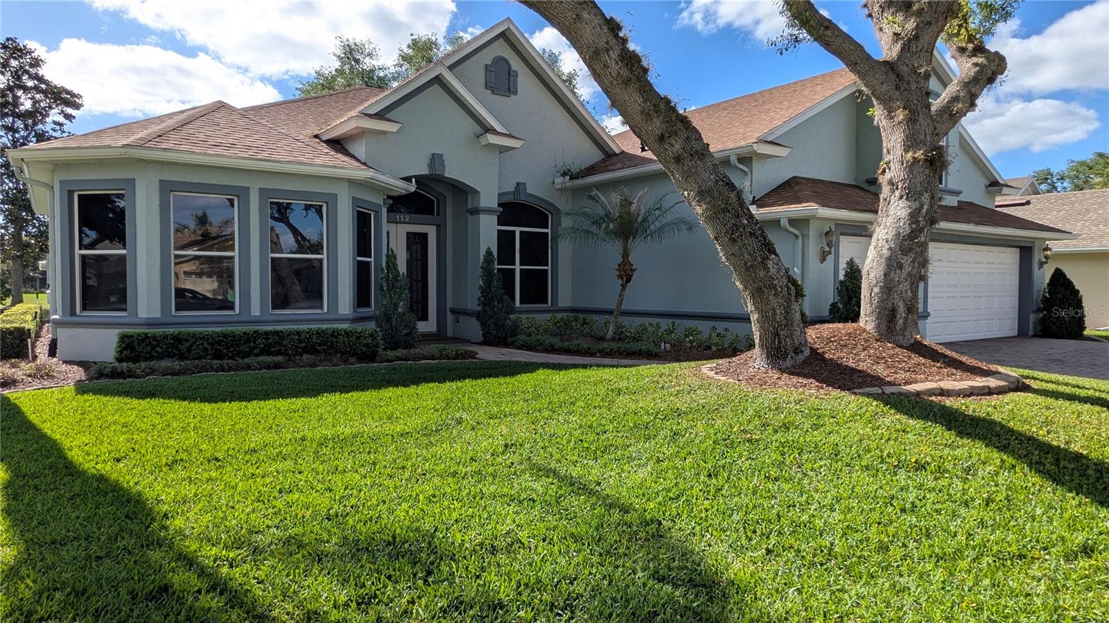 This stunning, spacious four-bedroom house is situated in the sought-after gated community of Hampton Hills Estates within the DeBary Golf and Country Club area. Nestled on a tranquil cul-de-sac, the home overlooks the water. It boasts a generously sized Great Room that flows into a formal dining area and kitchen. Additionally, there is an Office/Den/Library accompanied by French doors. The Master Bedroom Suite features a roomy walk-in closet with built-in enhancements and a Master Bathroom equipped with dual vanities, a jetted bathtub, and a separate walk-in shower. The split-layout includes two more bedrooms and a full bath on the first floor, with a sizable bedroom located upstairs. Among the numerous amenities are a spacious covered and screened lanai perfect for entertaining, which overlooks the pond in Hampton Hills Estates, a three-car garage with built-in cabinets, and a large paved driveway. The open floor plan offers water views from the entryway and continues through the living area and kitchen. The upgraded kitchen features 42-inch wood cabinetry, granite countertops, and essential appliances like a microwave, smooth-top range with convection oven, dishwasher, and refrigerator. The ceilings reach heights of 12 feet and 10 feet throughout, with 8-foot doors. This location is conveniently close to I-4, shopping centers, medical services, a hospital, Sun Rail, bus routes, schools, parks, and nature trails.