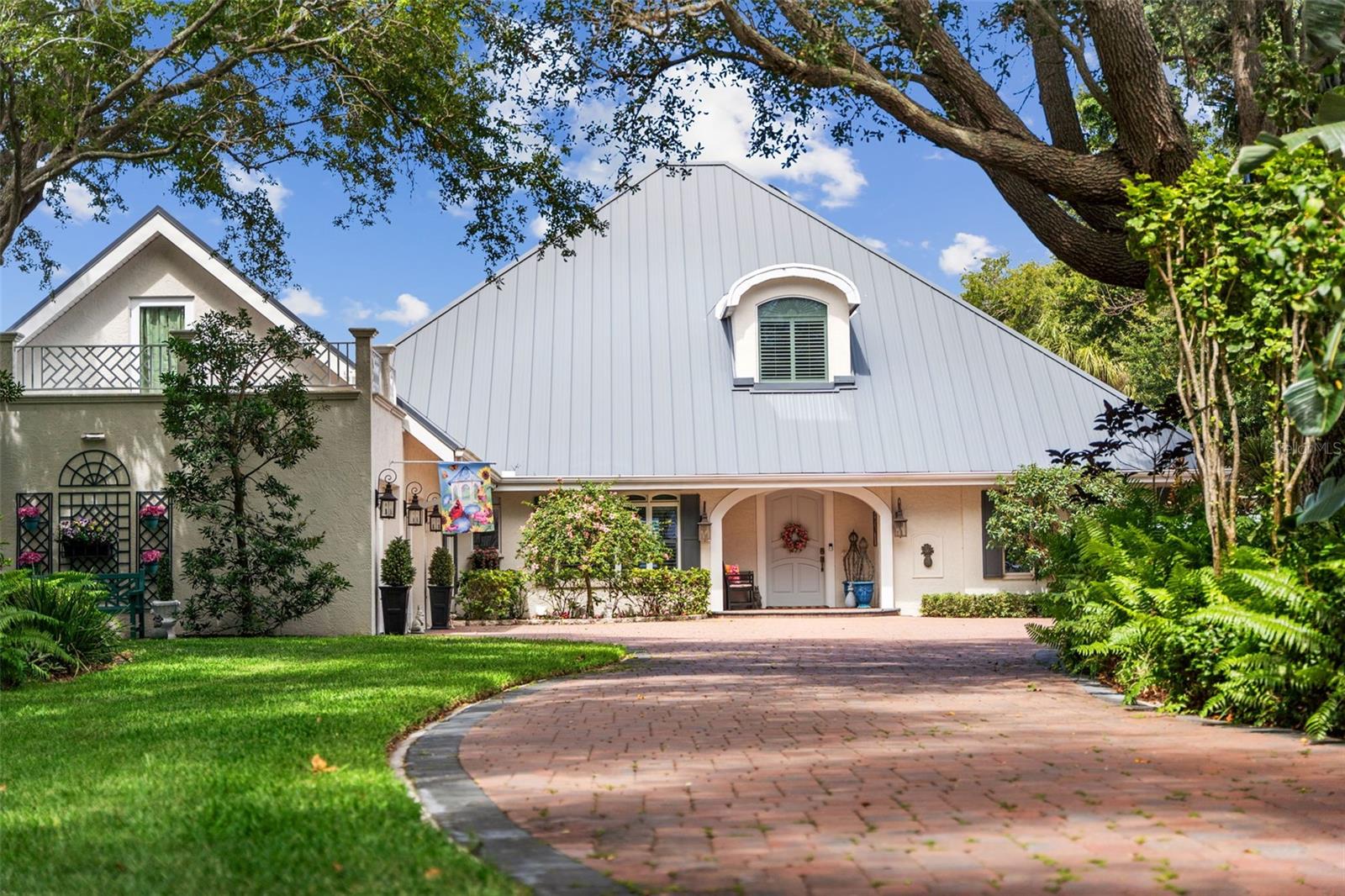 Discover timeless European elegance and exceptional gated waterfront living at this meticulously remodeled bay-front residence. This 4-bedroom, 3.5-bath home offers 4,383 square feet of refined living space on a spacious 37,800-square-foot lot with 100 feet of direct Sarasota Bay frontage. Enjoy breathtaking water views in a private, natural setting protected by mangroves, mature landscaping, and specimen plantings. The property sustained no flood damage during the 2024 storm season. Built in 2001 and fully transformed in 2016, the home features exceptional craftsmanship, handsome millwork, and thoughtful custom updates throughout. Soaring ceilings, an impressive entryway, engineered scraped maple and porcelain tile flooring, and abundant natural light create an open, inviting atmosphere ideal for both grand entertaining and relaxed everyday living. On the main floor, the home features a spacious living room with electric fireplace, a separate dining room which could double as an office, the kitchen and breakfast area, and a well-designed laundry room, plus 2 generous bedrooms that connect to a den/sitting area and a wet bar. The gourmet kitchen is a chef’s masterpiece, boasting quartz countertops, two islands, a pot filler, a large walk-in pantry, and premium appliances including a Sub-Zero refrigerator, Bosch dishwasher and gas range with custom hood, Samsung Duo-zone oven, microwave, and under-counter wine/beverage cooler. It also features solid wood custom cabinetry and a beautiful farmhouse double sink. A generous laundry room offers LG front-loading washer and dryer, solid wood cabinetry, a custom drying rack, and a built-in ironing board. The upstairs primary suite is a true retreat, complete with its own entry gallery and a private sitting room featuring a cathedral ceiling. Step out onto the large private balcony overlooking the pool, lush gardens, and sailboats on Sarasota Bay. The luxurious primary bath includes a large shower, double vanity, a separate built-in dressing table, and a spacious 13’ x 16’ his-and-her's walk-in closet with custom organization and display features. The versatile fourth bedroom functions as a garage apartment, offering a main-floor living room and kitchenette, plus a large second-floor bedroom and bath with its own private balcony—perfect for guests, a caregiver, or extended family. Outside, resort-style living awaits on the expansive covered patio overlooking a 45’ x 15’ private pool, beautiful landscaping, and panoramic Sarasota Bay views. Additional highlights include a full irrigation system with well, a 2018 standing seam metal roof, tankless water heater, updated HVAC systems, and a well-positioned outdoor kitchen with a Blaze grill. Perfectly located just three miles north of downtown Sarasota, this exceptional bay-front home is minutes from the Ringling Museum, Ringling College of Art and Design, SRQ International Airport, fine dining, cultural venues, St. Armands Circle, and the pristine Gulf Coast beaches.