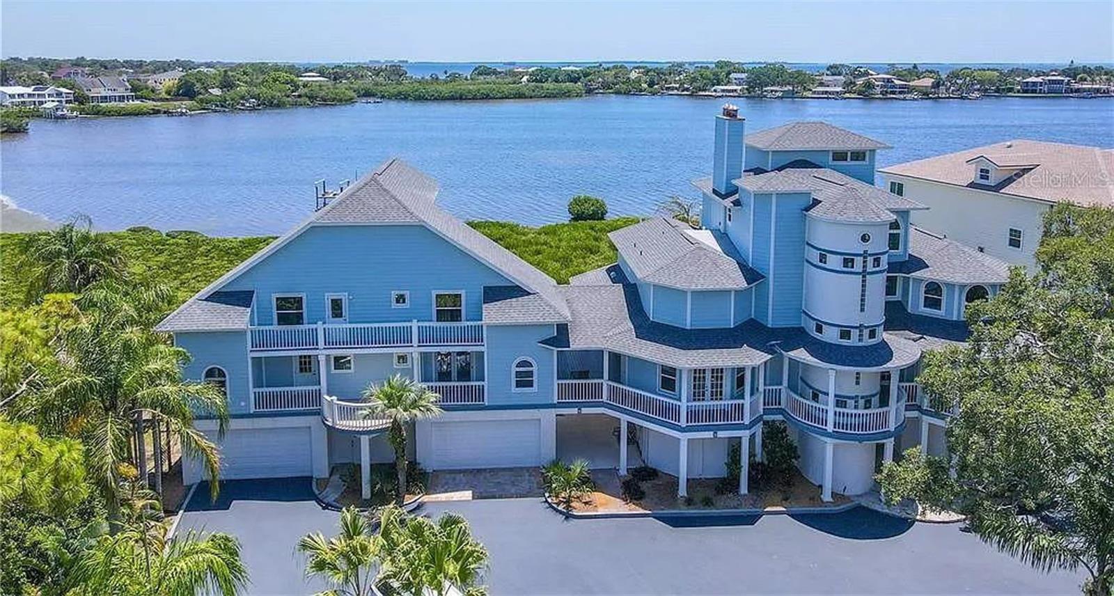 One or more photo(s) has been virtually staged. Welcome to an extraordinary waterfront estate set on over 1.1 acres with a private gated entrance and an impressively over 300ft driveway that creates a true sense of arrival. This exceptional property offers unmatched privacy, breathtaking Gulf Views, and luxury living at every turn.
The main residence features a spacious split-floor plan with 6 bedrooms and 5 bathrooms, thoughtfully designed for both comfort and grand entertaining. This luxury home is designed to impress, featuring a four stop elevator offering convenient access to all levels. Travertine flooring flows seamlessly from the living room into the chef’s kitchen, showcasing brand-new custom cabinetry, quartz countertops, a Sub-Zero refrigerator, new appliances, a walk-in pantry, and stunning panoramic water views while you're cooking.
Indoor and outdoor living blend effortlessly with French doors opening to a massive balcony overlooking the Gulf, providing the perfect setting to enjoy spectacular sunsets. Outside, relax beneath swaying palms or enjoy resort style living by the saltwater pool and jacuzzi, both overlooking the water and equipped with all new pool pumps and custom LED lighting. Boaters will appreciate the brand-new 11,000-lb boat lift, while car enthusiasts will love the 6 car garage. Additional features include a private movie theater room, custom closets, brand-new bathrooms, reverse osmosis system(2025), water softener (2024), cement siding(2023), newer roof, all hurricane-impact windows and doors(2024), custom shutters (2025) and much more, complete the homes extensive upgrades. The primary suite occupies the fourth floor, offering French doors that open to a private balcony, surrounded by water views and unforgettable sunsets. The spa-inspired primary bath features a stand-alone soaking tub beside a window overlooking the water, double vanities, a massive walk-in shower, and a walk-in closet. An exclusive observation deck above the primary suite provides a serene space to relax, read, take in panoramic sunset views, or stargaze.
Completing this exceptional property is a detached, fully remodeled 3 bedroom, 3 bath GUEST HOUSE with panoramic Gulf views, featuring a full kitchen, laundry room with washer and dryer, and four private balconies—ideal for extended family, guests, a Potential Income-Producing Airbnb or Rental. 
Ideally, located next to Wall Springs Park, with steps down the street to the Pinellas Trail, this home sits near some of the areas, most desirable destinations, including Innisbrook Golf Course, the iconic Tarpon Springs, Downtown Palm Harbor, and Dunedin. Enjoy an incredible selection of top, rated restaurants, shopping, and boutique experiences across all three vibrant communities all just 30 minutes from Tampa International Airport. 
With its elevated position as the highest home on the street, this residence withstood both recent hurricanes and is located in a favorable AE flood zone designation, contributing to lower flood insurance rates.
This is a Rare Opportunity to own a Private Gulf-front compound combining luxury, functionality, and endless lifestyle possibilities. Call and book your private showing today!!
